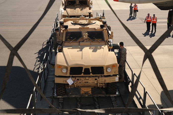 Airmen with the 437th Aerial Port Squadron transport a mine-resistant, ambush-protected all-terrain vehicle from one Tunner 60K Loader to another as they prepare to load it onto a Boeing 747-400 aircraft here Nov. 7. The 437 APS air transportation specialists utilized two 60K loading vehicles together to expedite the loading process. (U.S. Air Force photo/Staff Sgt. Marie Brown)