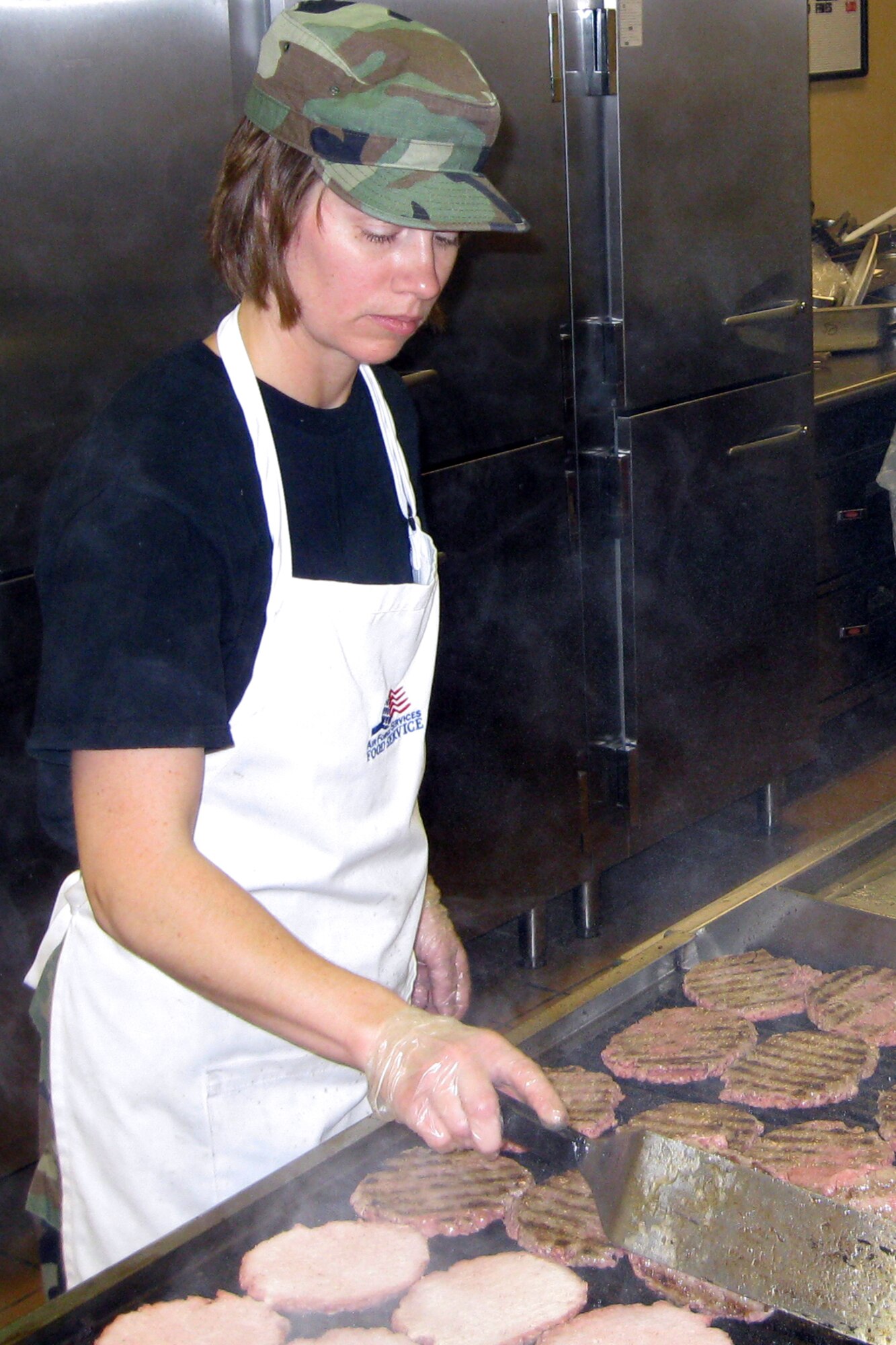 GRISSOM AIR RESERVE BASE, Ind., -- Senior Airman Christina Williams, 434th Services Flight, works the grill during the November unit training assembly.  Airmen dining at the base on unit training assemblies are afforded a variety of food choices from fast-type food to more conventional sit-down type fare. (U.S. Air Force photo/Staff Sgt. Chris Bolen)                     