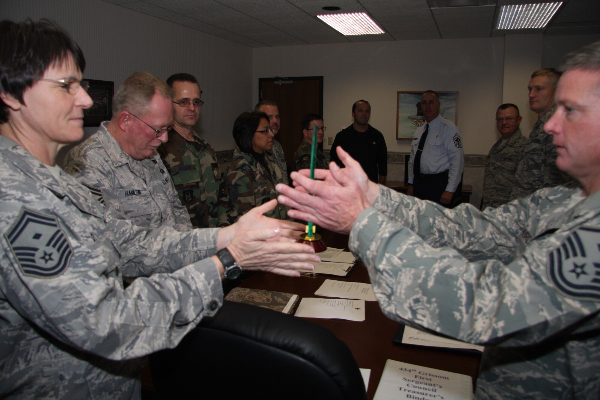 GRISSOM AIR RESERVE BASE, Ind., -- Grissom first sergeants pass a plaque around the room before presenting it to Master Sgt. Kevin Smith, 434th Mission Support Squadron first sergeant. Sergeant Smith retired recently and was recognized by his fellow first sergeants.  (U.S. Air Force photo/Staff Sgt. Mark Orders-Woempner)