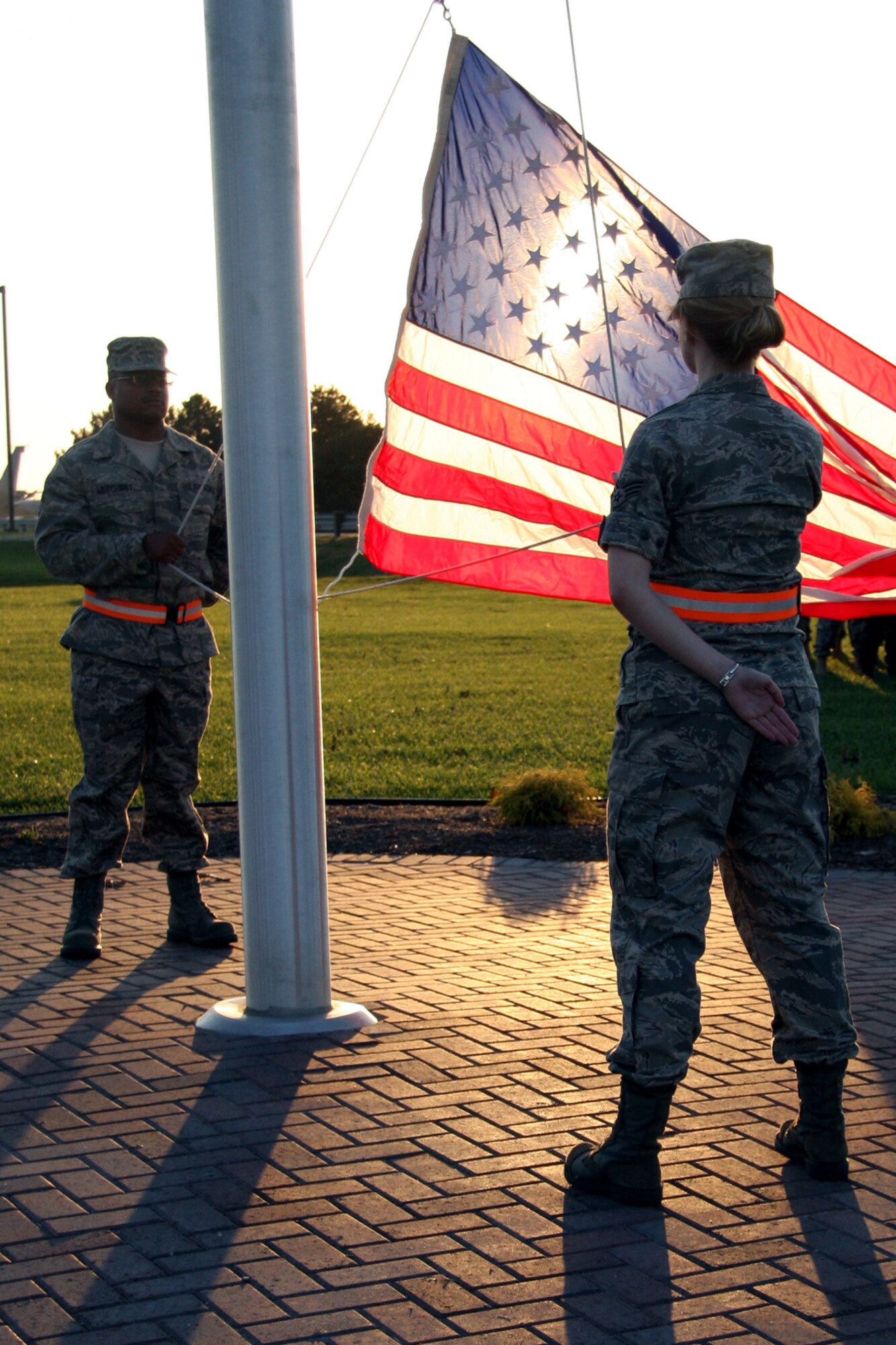 GRISSOM AIR RESERVE BASE, Ind., -- Staff Sgt. Gerald Merchant, an information management specialist, and Senior Airman Michaela McClintock, an inventory specialist, both with the 434th Logistics Readiness Squadron, await the sounding of reveille. Members of the 434th LRS stood in formation for the ceremony during the November unit training assembly. (U.S. Air Force photo/Staff Sgt. Mark Orders-Woempner)