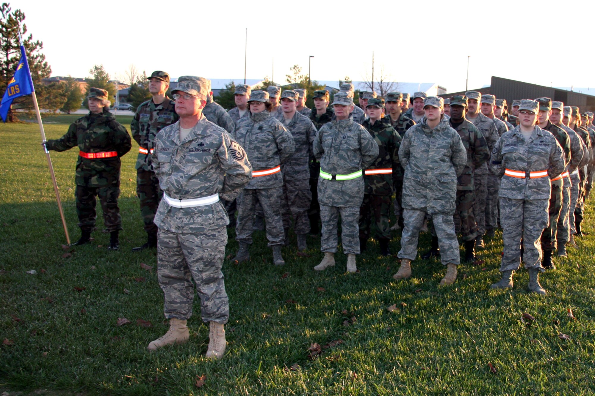 GRISSOM AIR RESERVE BASE, Ind., -- Members of the 434th Logistics Readiness Squadron, stand in formation for reveille in the early morning hours on Nov. 4. Grissom plays reveille at 8 a.m. and retreat at 4 p.m. daily. (U.S. Air Force photo/Staff Sgt. Mark Orders-Woempner)