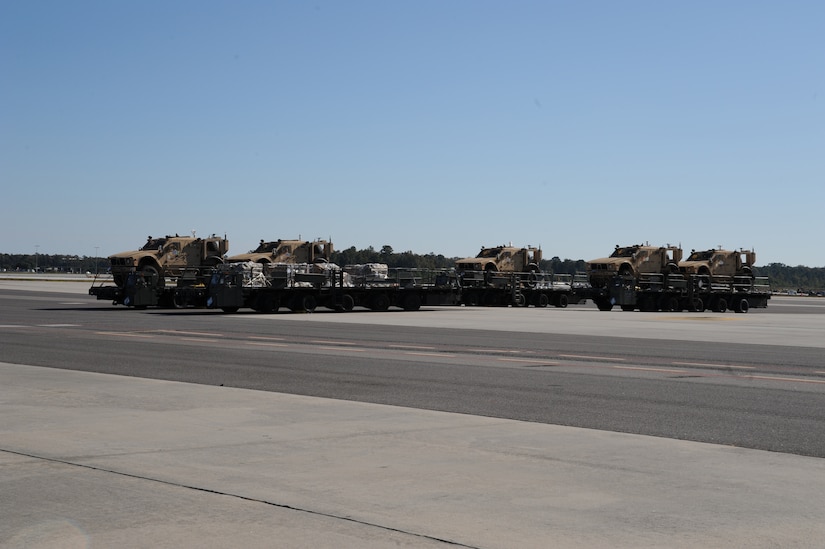 Five new mine-resistant, ambush-protected all-terrain vehicles sit on the flightline as they are prepared to be loaded onto a Boeing 747-400 aircraft here Nov. 7. Charleston AFB serves as the primary aerial port for M-ATV shipments to Afghanistan. (U.S. Air Force photo/Staff Sgt. Marie Brown)