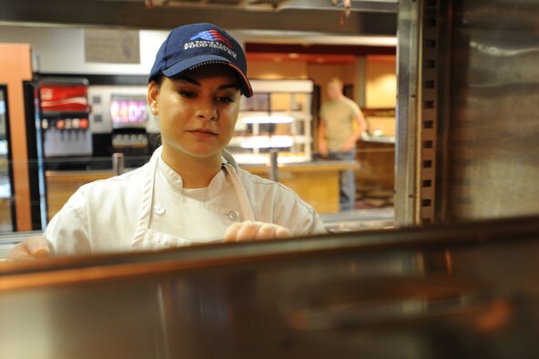 WHITEMAN AIR FORCE BASE, Mo. - Airman 1st Class Tatiana Niles, 509th Force Support Squadron member, retrieves food from the warmer that was just been prepped, Nov. 9. The Ozark Inn Dining Facility is currently undergoing the Hennessey Award inspection, which looks at their food, service and operations.(U.S. Air Force photo by Airman 1st Class Carlin Leslie) (Released)

 