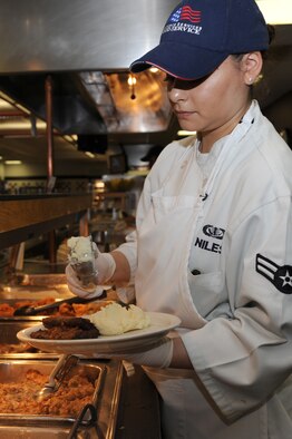 WHITEMAN AIR FORCE BASE, Mo., - Airman 1st Class Tatiana Niles, 509th Force Support Squadron member, serves Airmen during dinner time, Nov. 9. The Ozark Inn Dining Facility is currently undergoing the Hennessey Award inspection, which looks at their food, service and operations.(U.S. Air Force photo by Airman 1st Class Carlin Leslie) (Released)