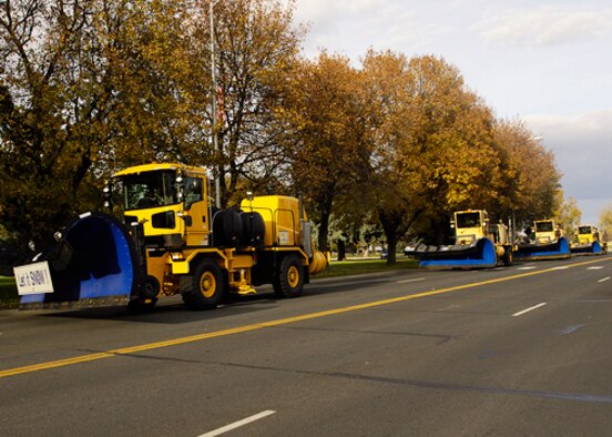 FAIRCHILD AIR FORCE BASE, Wash. ? Snow plows make a run past the 92nd Air Refueling Wing headquarters building during the annual snow parade here Oct. 28. (U.S. Air Force photo / Staff Sgt. Eunique Stevens) 