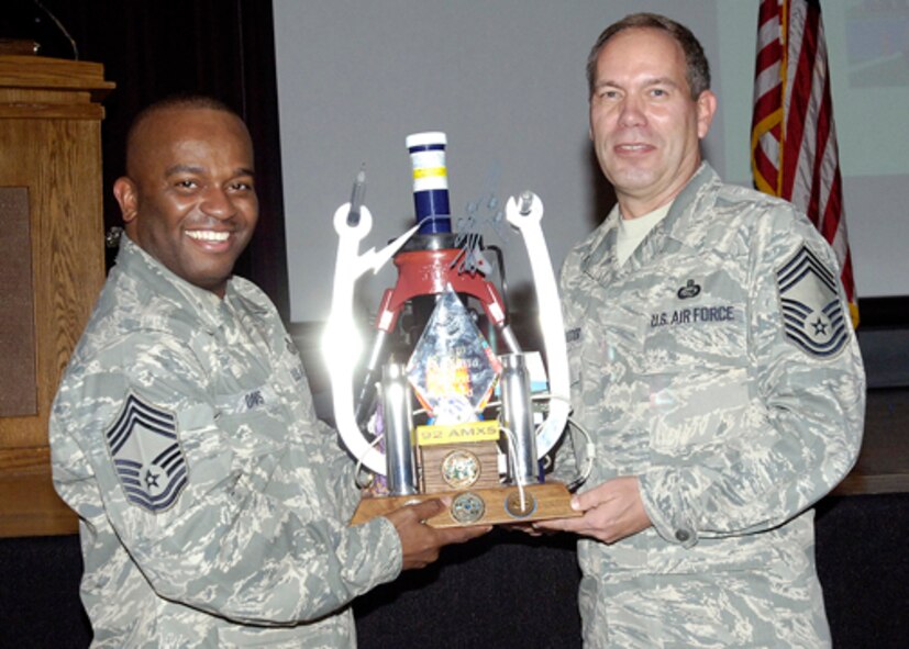 FAIRCHILD AIR FORCE BASE, Wash. - Chief Master Sgt. Michael Davis, 92nd Mission Support Group superintendent, accepts the spirit award from Chief Master Sgt. Donald Schroader, 92nd Force Support Squadron superintendent, during the quarterly awards ceremony here Oct. 30. The spirit award is awarded to the squadron that demonstrates the most enthusiasm and support for their fellow Airmen at the Quarterly Awards Ceremony.  (U.S. Air Force photo / Staff Sgt. Eunique Stevens) 