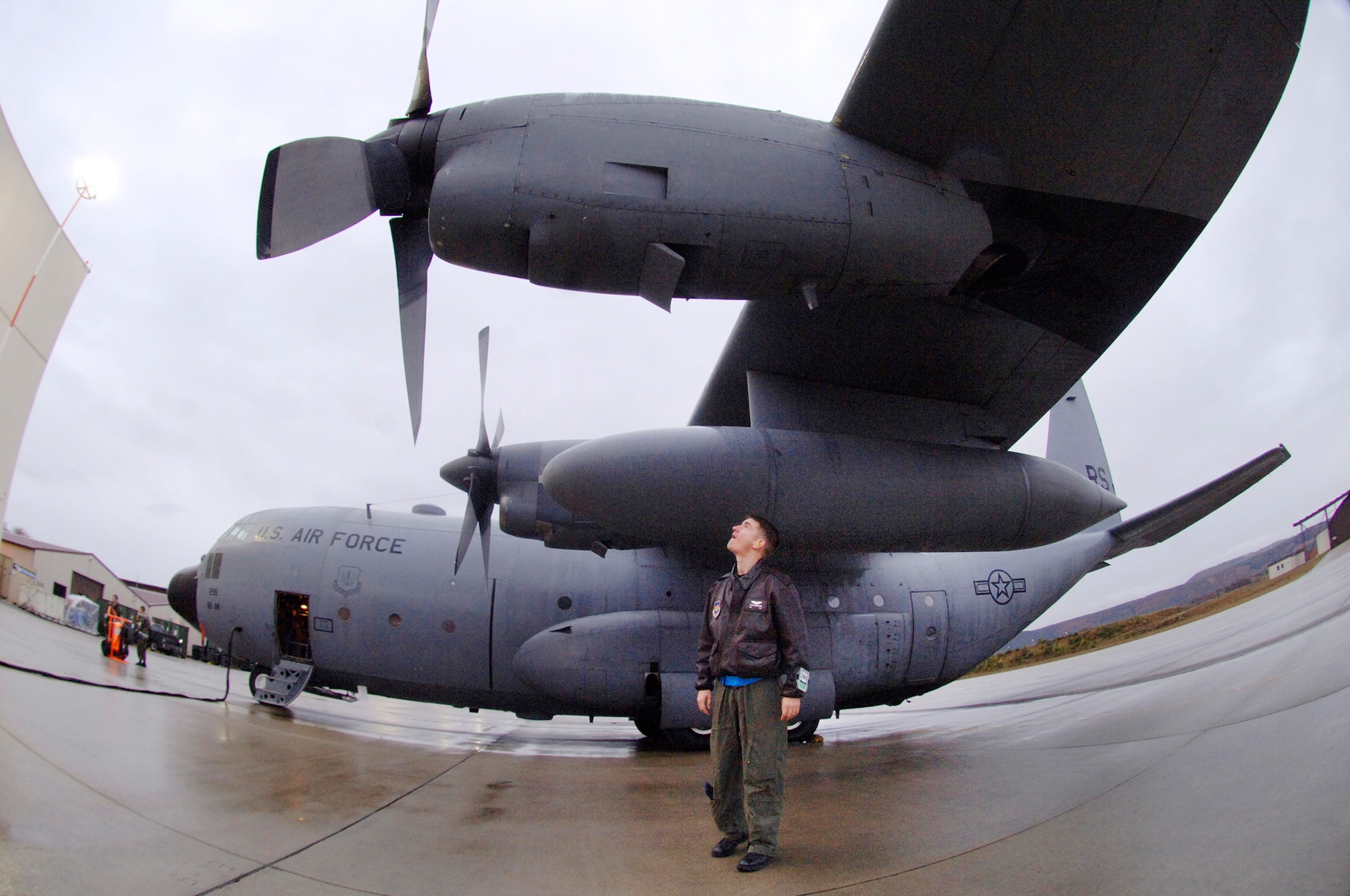 Capt. Tyler Robertson performs a walk around inspection prior to engine start up before piloting the last E-model C-130 Hercules Nov. 2, 2009, from Ramstein Air Base, Germany, to Powidz Air Base, Poland. (Defense Department photo/Master Sgt. Scott Wagers)