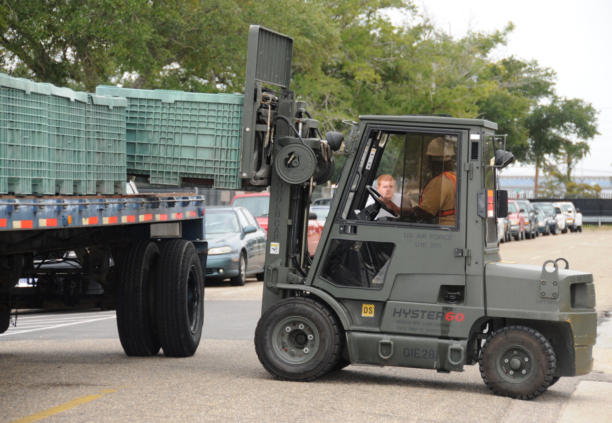 Forklift operator Gerald Rivers and Bobby Rice remove pallets of sandbags behind the medical center  Monday.  Tropical Storm Ida, previously a Category 2 hurricane, moved ashore with 50 mph winds at 5:40 a.m. 48 miles away on Dauphin Island, Ala. (U.S. Air Force photo by Kemberly Groue)
