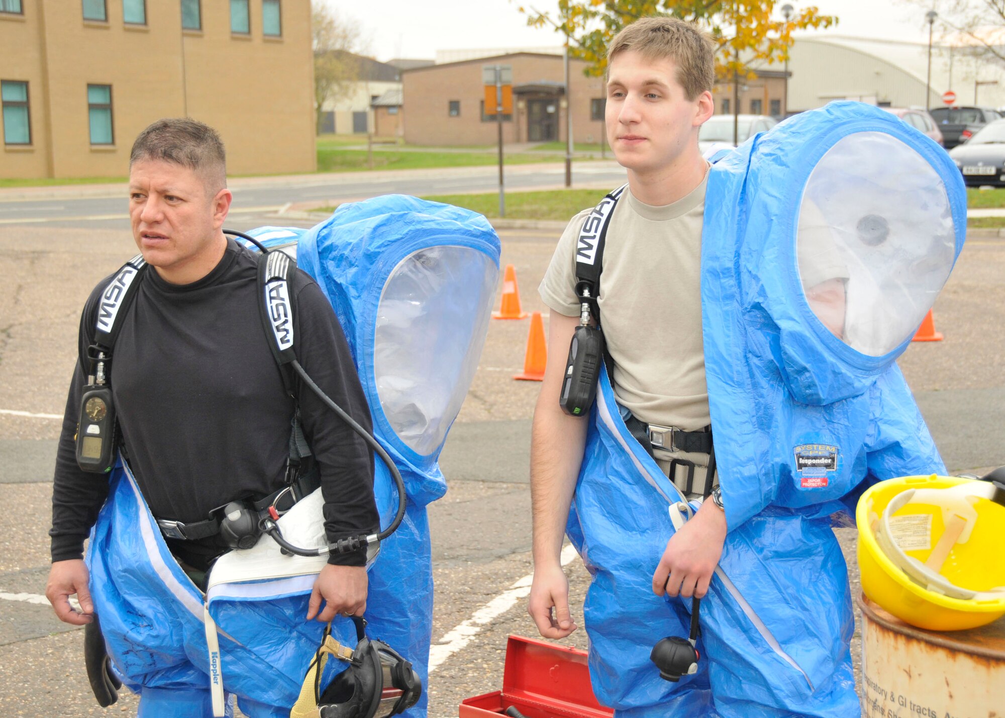 Master Sgt. Vincente Navejas (left) and Airman 1st Class Matthew Kindoll, 48th Medical Group bioenvironmental technicians, rest after going through a damage scenario during the final practical evaluation for the hazardous material technician certification at RAF Lakenheath, England, Oct 30.  (U.S. Air Force photo/Airman 1st Class Eboni Knox)
