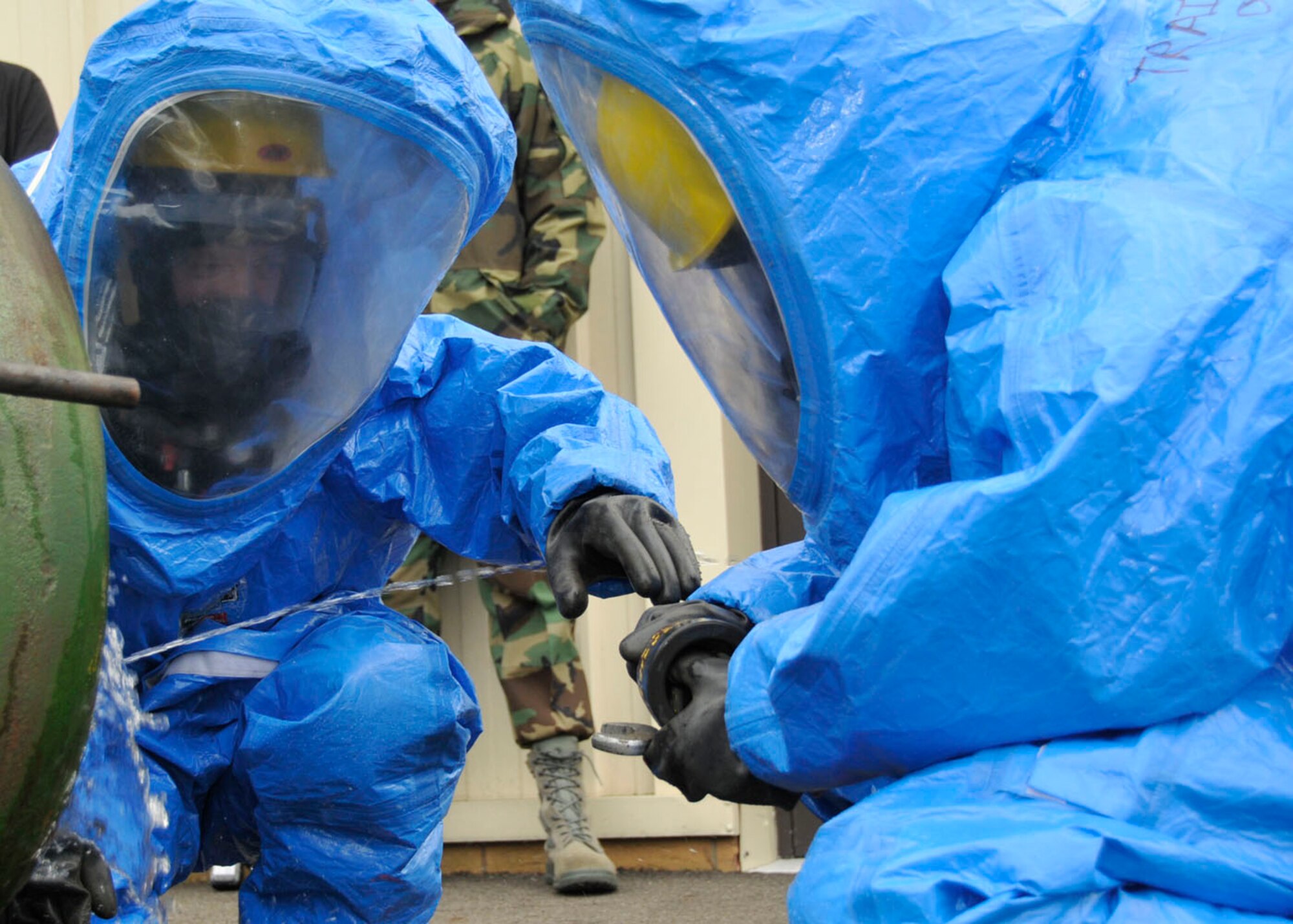 Master Sgt. Vincente Navejas and Airman 1st Class Matthew Kindoll, 48th Medical Group bioenvironmental technicians, fix a simulated hazardous leak accident to earn their hazardous material technician certification at RAF Lakenheath, England, Oct 30. The hazardous leak is one of three scenarios during the evaluation. (U.S. Air Force photo/Airman 1st Class Eboni Knox)