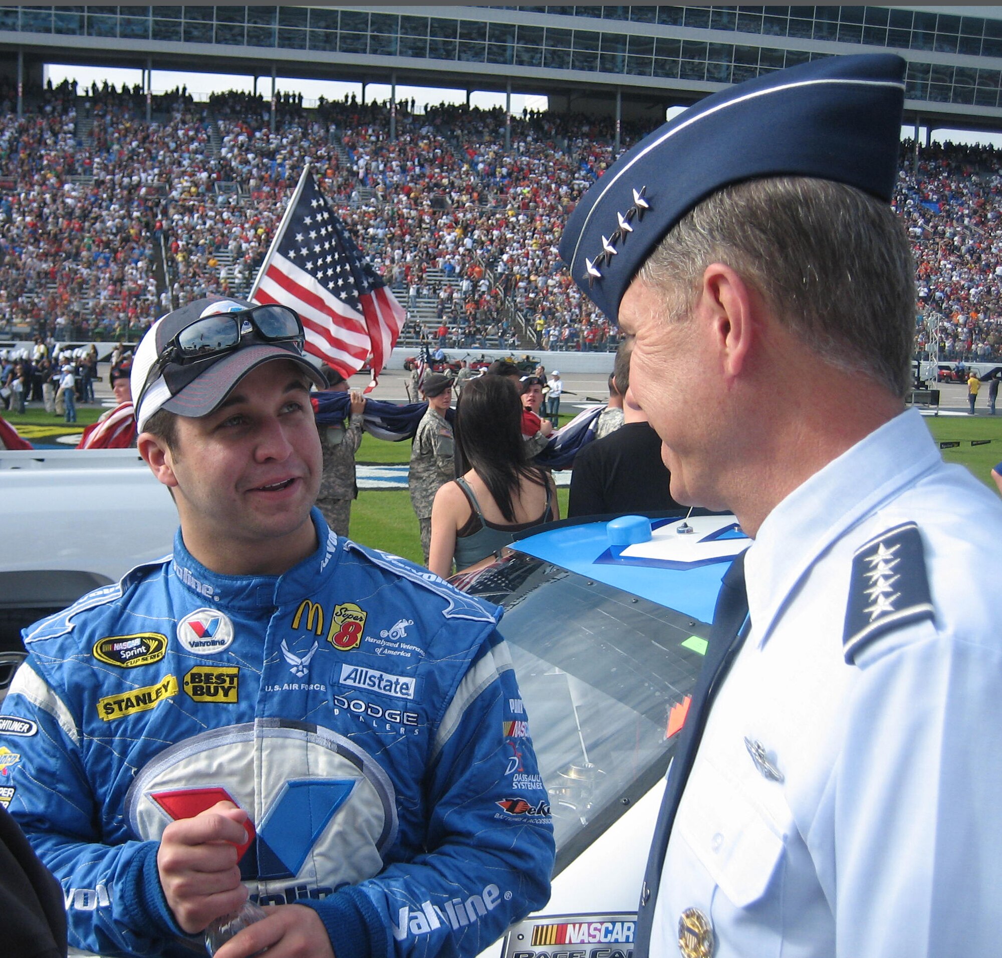 FORT WORTH, Texas – U.S. Air Force Sprint Cup NASCAR driver Reed Sorenson and Gen. William M. Fraser III, commander of Air Combat Command, discuss pre-race strategy before the Dickies 500 at the Texas Motor Speedway Nov. 8. Before the race, General Fraser administered the oath of enlistment to 21 Airmen, who are part of the Air Force's Delayed Enlistment Program. (U.S. Air Force photo/Tom Holloway)