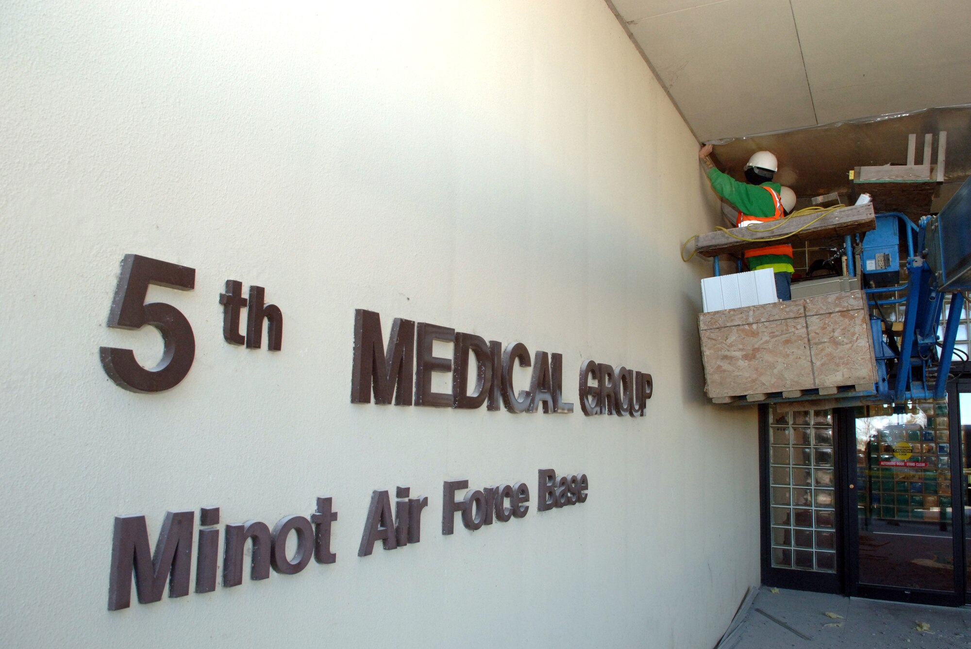 MINOT AIR FORCE BASE, N.D. -- Jeff and Devin Blowers, a father and son construction team, make improvements to the overhang to ensure ease of repair of the vacuum system for the dental clinic of the 5th Medical Group here, Nov. 6. Projects such as these are part of the ongoing improvements to the living and working environment at Minot AFB. (U.S. Air Force photo by Senior Airman Michael Veloz) 