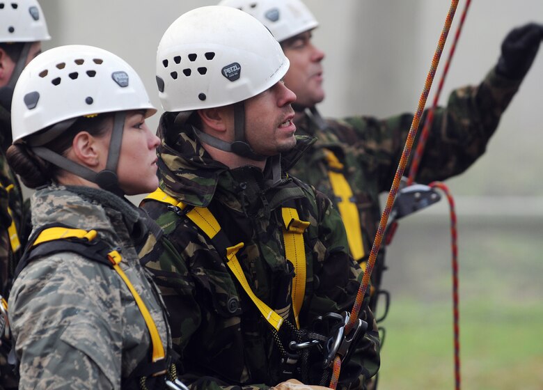RAF MILDENHALL, England -- Staff Sgt. Samantha Webb, 48th Security Forces Squadron, talks with a British airman at the high-ropes course at RAF Marham Nov. 9. The Airmen were participants of Leadership, Ethos and Air Power Day, a leadership building event hosted by the camp three times a year. About 40 U.S. Airmen from RAFs Mildenhall and Lakenheath were invited to attend the teambuilding activities. (U.S. Air Force photo/Senior Airman Thomas Trower)