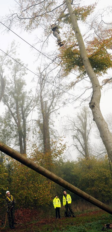 RAF MILDENHALL, England -- Staff Sgt. Samantha Webb, 48th Security Forces Squadron, scales a segment of the high-ropes course at RAF Marham Nov. 9. She is belayed by a British airman about 50 feet below during the Leadership, Ethos and Air Power Day, a leadership building event hosted by the camp three times a year. About 40 U.S. Airmen from RAFs Mildenhall and Lakenheath were invited to attend the teambuilding activities. (U.S. Air Force photo/Senior Airman Thomas Trower)
