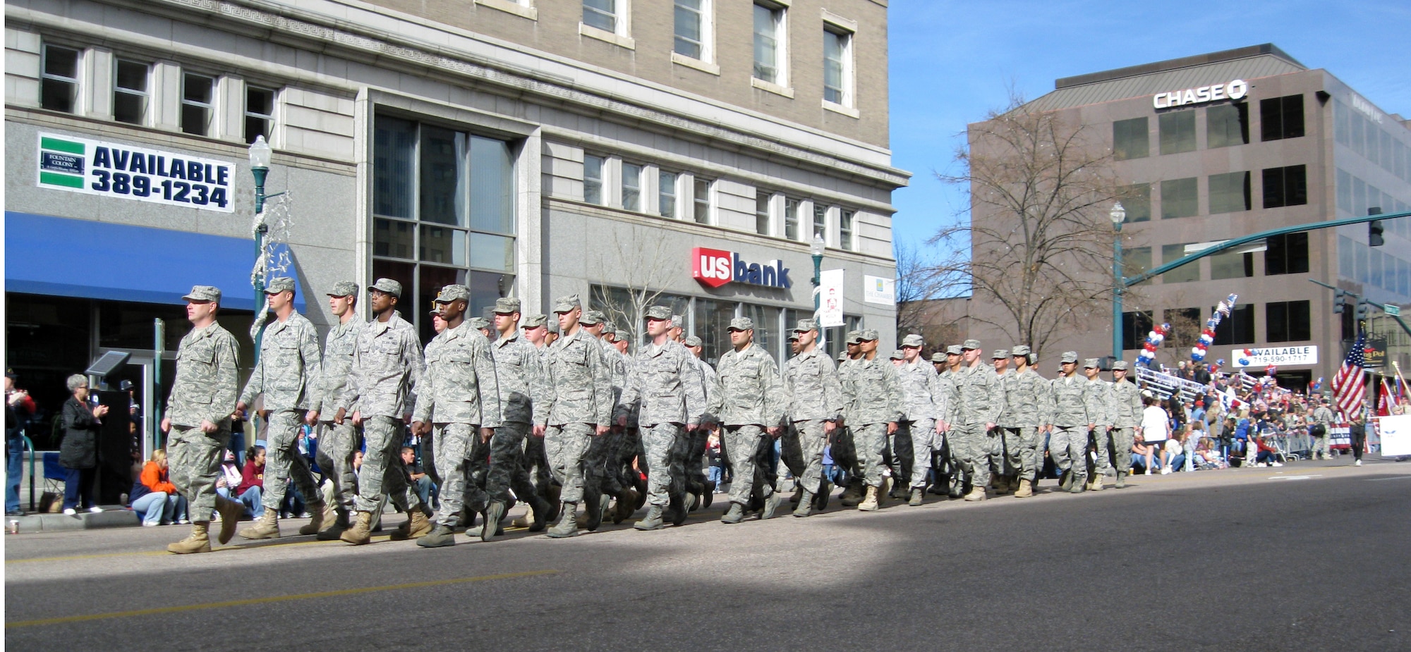 Airmen from the 21st Space Wing marched in the annual Colorado Springs Veterans Day parade Nov. 7. The 21st SW flight represented the more than 800 warrior Airmen the wing deploys each year in response to combatant commander taskings. More than 100 floats, bands and military units participated in the salute to veterans, including a flyover by two C-130s from the 302nd Airlift Wing stationed at Peterson. (Air Force photo by Steve Brady)

