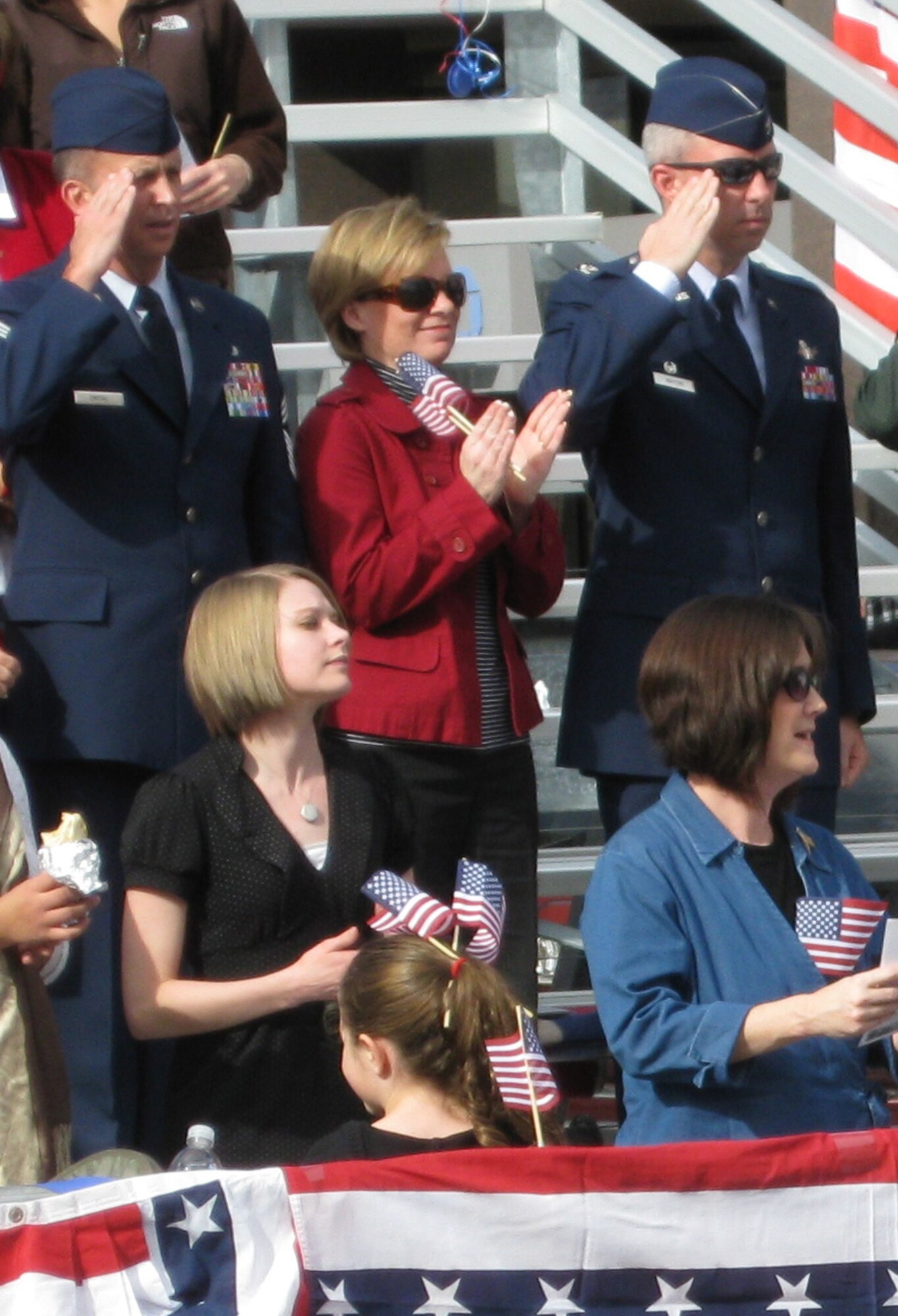 (Left to right) Chief Tim Omdal, 21st Space Wing command chief, Tammy Whiting and Col. Stephen N. Whiting, 21st SW commander, join the community to honor veterans during the annual Colorado Springs Veterans Day parade Nov. 7. A 21st SW flight of Airmen represented the more than 800 warrior Airmen the wing deploys each year in response to combatant commander taskings. More than 100 floats, bands and military units participated in the salute to veterans, including a flyover by two C-130s from the 302nd Airlift Wing stationed at Peterson. (Air Force photo by Steve Brady)