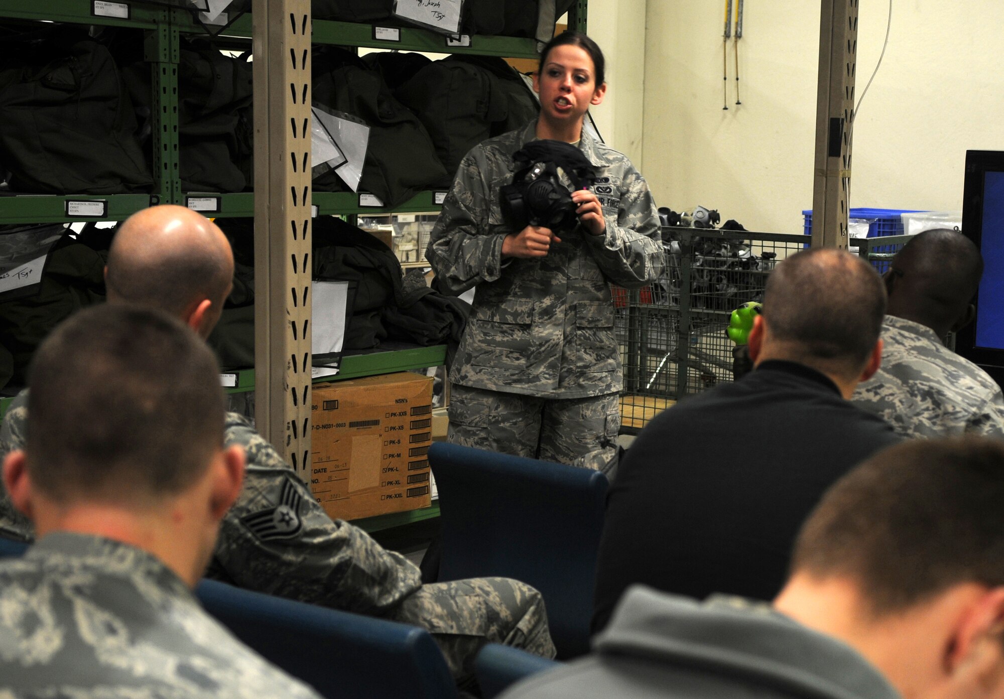 U.S. Air Force Airman 1st Class Renee Malsom, 886th Civil Engineer Squadron, Ramstein Air Base, Germany, briefs a class on the proper usage of the new M50 protective mask, November 09, 2009.  The M50 protective mask will be replacing the MCU-2P protective mask. (U.S. Air Force photo by Staff Sgt. Charity Barrett)
