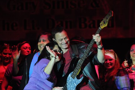 Gary Sinise gets crowd participation during the Lt. Dan Band concert at Randolph Air Force Base Nov. 6.  The Lt. Dan Band covers everything from Aretha Franklin to Linkin Park. (U.S. Air Force photo/Rich McFadden)