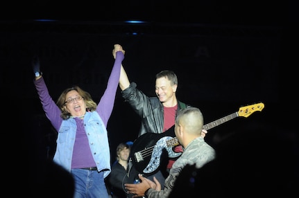 Gary Sinise celebrates with a fan as Chief Master Sgt. Max Grindstaff, 12th Flying Training Wing command chief master sergeant, applauds the performance during the Lt. Dan Band concert at Randolph Air Force Base Nov. 6.  (U.S. Air Force photo/Rich McFadden)