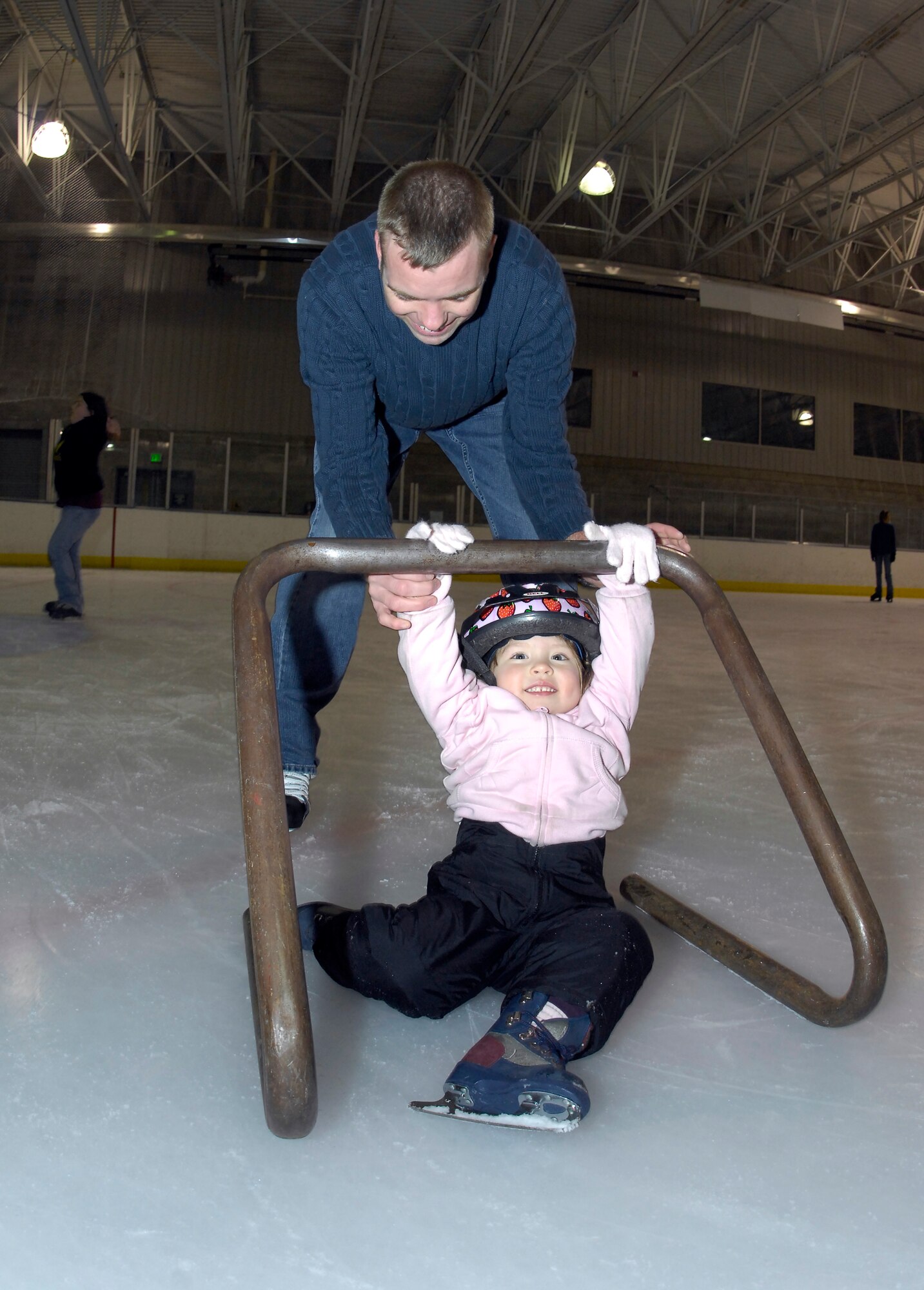 MINOT, N.D. -- 2nd Lt. Jon Hoffman, 740th Missile Squadron deputy-in-training missile commander, teaches his daughter, Allison, how to skate at the Maysa Arena Nov. 6 here. The two came to skate as one of the activities the Airman and Family Readiness Center put together for Air Force Family Week. The purpose of the week’s events is to focus collective attention of AF leadership on its families and recognize their service. (U.S. Air Force photo by Airman 1st Class Benjamin Stratton)
