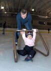 MINOT, N.D. -- 2nd Lt. Jon Hoffman, 740th Missile Squadron deputy-in-training missile commander, teaches his daughter, Allison, how to skate at the Maysa Arena Nov. 6 here. The two came to skate as one of the activities the Airman and Family Readiness Center put together for Air Force Family Week. The purpose of the week’s events is to focus collective attention of AF leadership on its families and recognize their service. (U.S. Air Force photo by Airman 1st Class Benjamin Stratton)