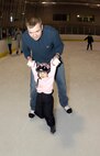 MINOT, N.D. -- 2nd Lt. Jon Hoffman, 740th Missile Squadron deputy-in-training missile commander, teaches his daughter, Allison, how to skate at the Maysa Arena Nov. 6 here. The two came to skate as one of the activities the Airman and Family Readiness Center put together for Air Force Family Week. The purpose of the week’s events is to focus collective attention of AF leadership on its families and recognize their service. (U.S. Air Force photo by Airman 1st Class Benjamin Stratton)