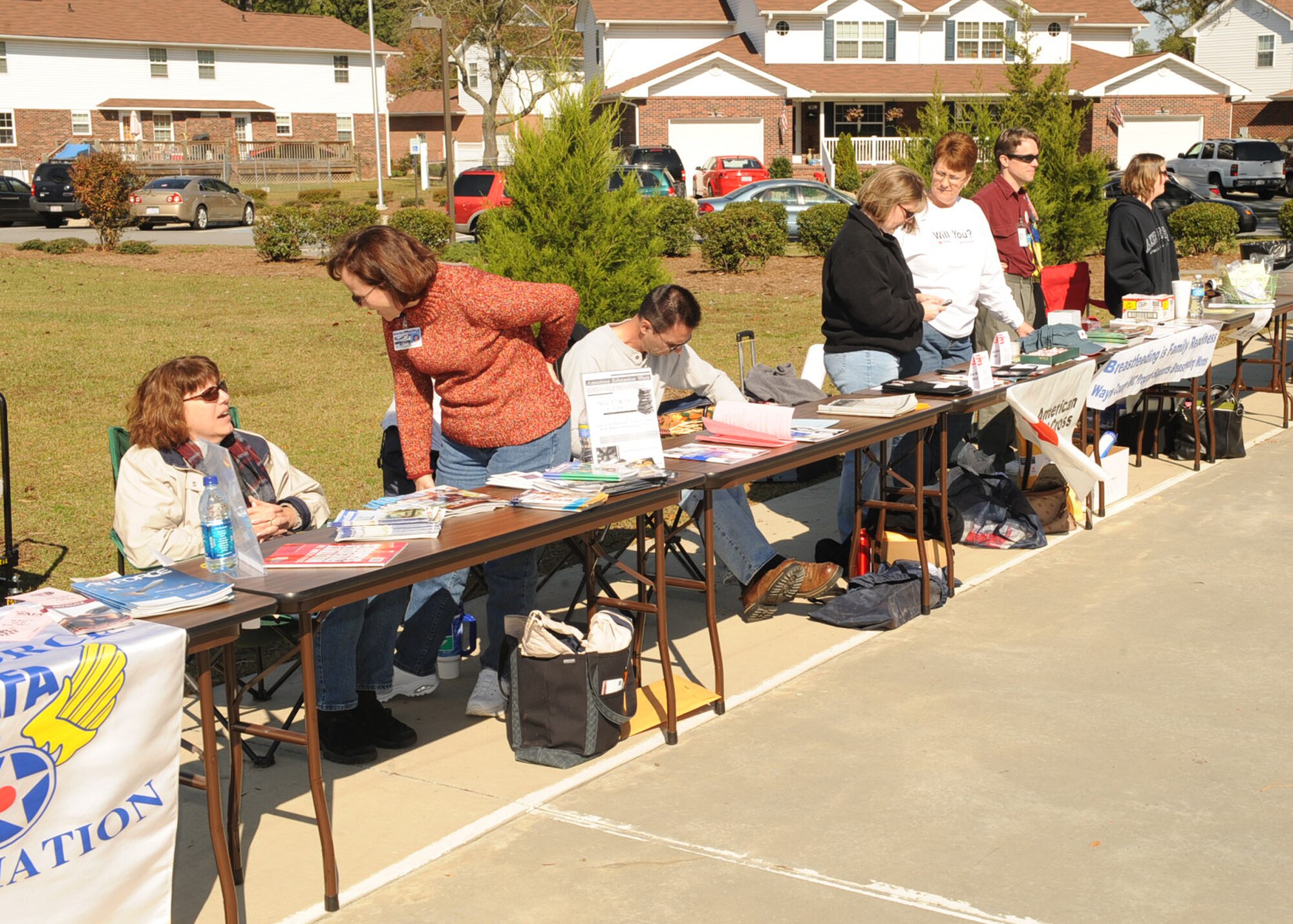 Representatives from Seymour Johnson Air Force Base agencies manned information booths during "Taking it to the Streets" in family housing on Nov. 7, 2009. During the event, booths were set up by the Airmen and Family Readiness Center, family advocacy, mental health, school liaison office, Health and Wellness Center and the sexual assault response office. (U.S. Air Force photo/Senior Airman Ciara Wymbs) 