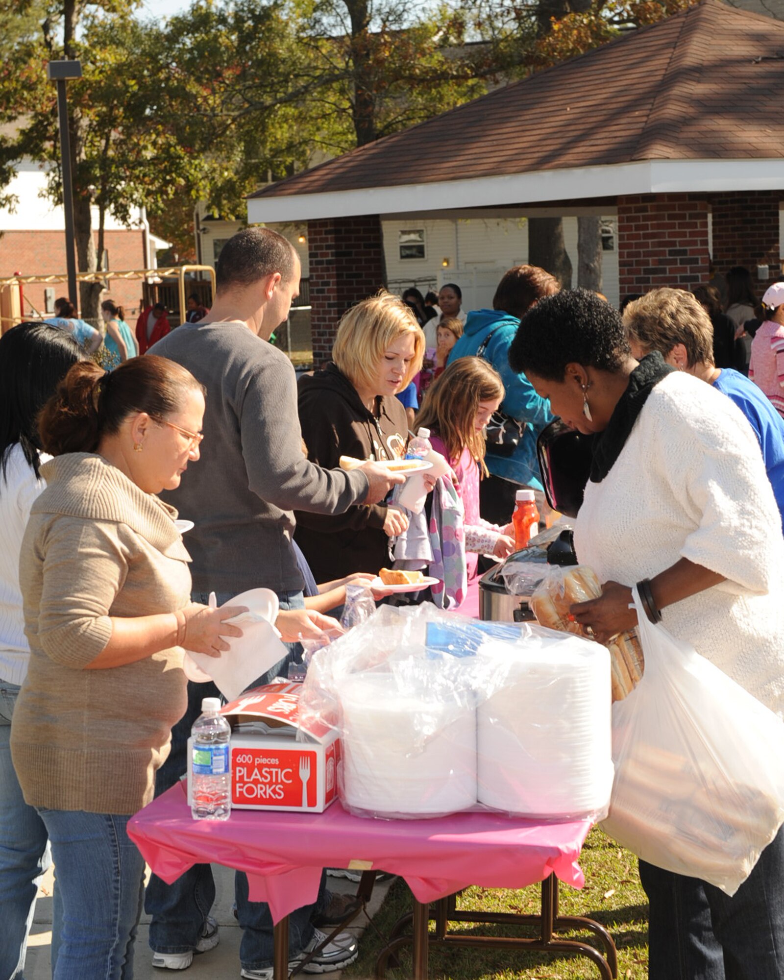 Members from the Airmen and Family Readiness Center serve food to families during "Taking it to the Streets" on Seymour Johnson Air Force Base, N.C., Nov. 7, 2009. The event also offered entertainment and a chance to win $1,000 in door prizes. (U.S. Air Force photo/Senior Airman Ciara Wymbs) 
