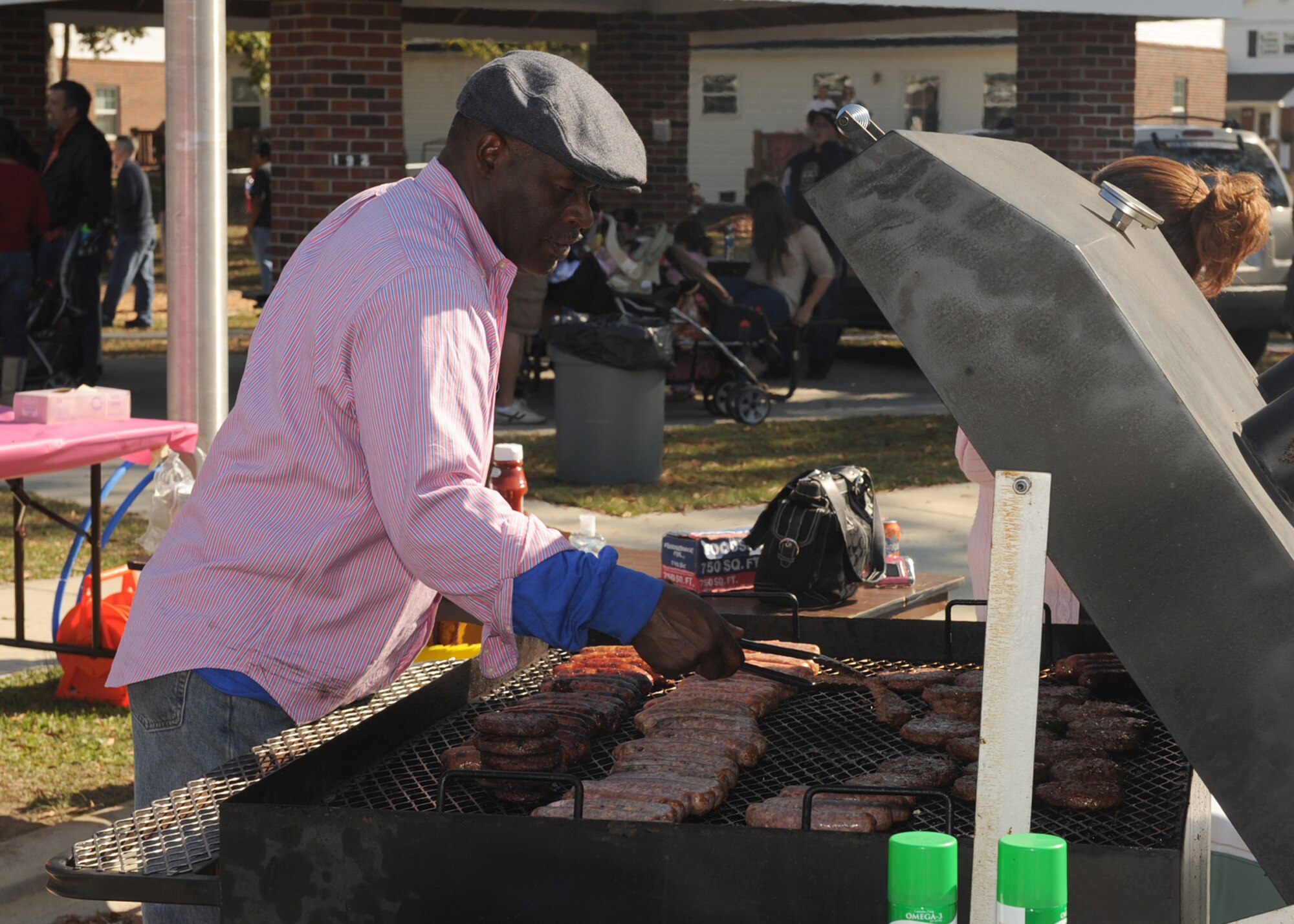 Jay Jenkins, Airman and Family Readiness Center community readiness technician, grills burgers and hot dogs during "Taking It to the Streets?" on Seymour Johnson Air Force Base, N.C., Nov. 7, 2009. The event took place in Berkeley Village, a central location to the families living on base, and was free for active duty, retirees and their dependents. (U.S. Air Force photo/Senior Airman Ciara Wymbs) 