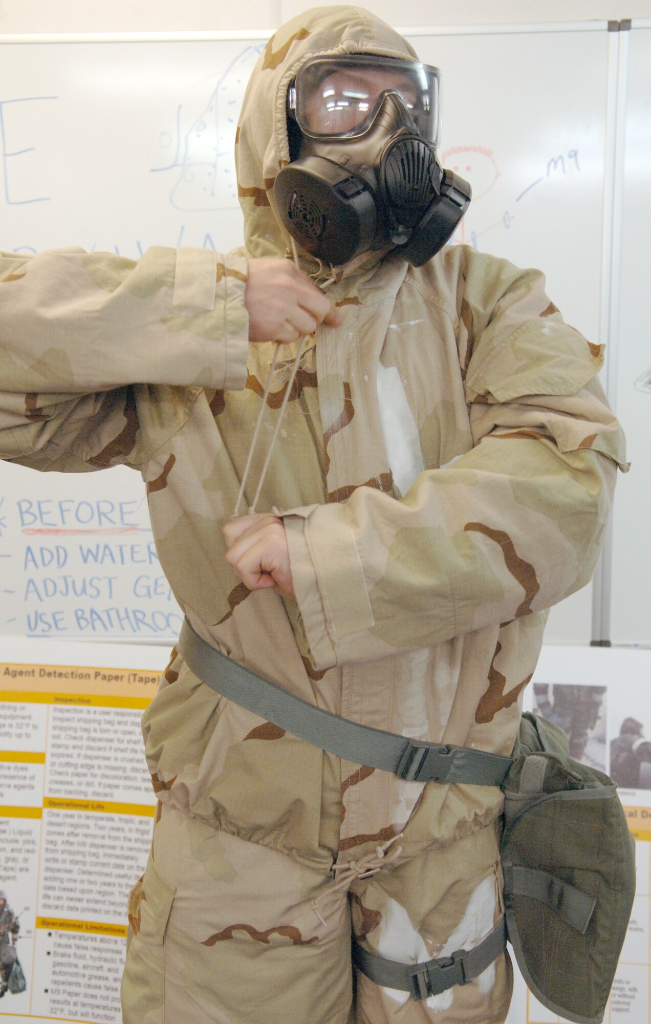 U.S. Air Force Airman 1st Class Michael Balbaugh, 886th Civil Engineer Squadron readiness and emergency management apprentice, demonstrates the proper wear of the Joint Service Lightweight Integrated Suit Technology with the M-50 Joint Service General Purpose Mask, Nov. 5, 2009, Ramstein Air Base, Germany. Both the mask and the chemical suit are required for Chemical, Biological, Radiological and Nuclear training at Ramstein.  (U.S. Air Force photo by Senior Airman Amanda Dick)
