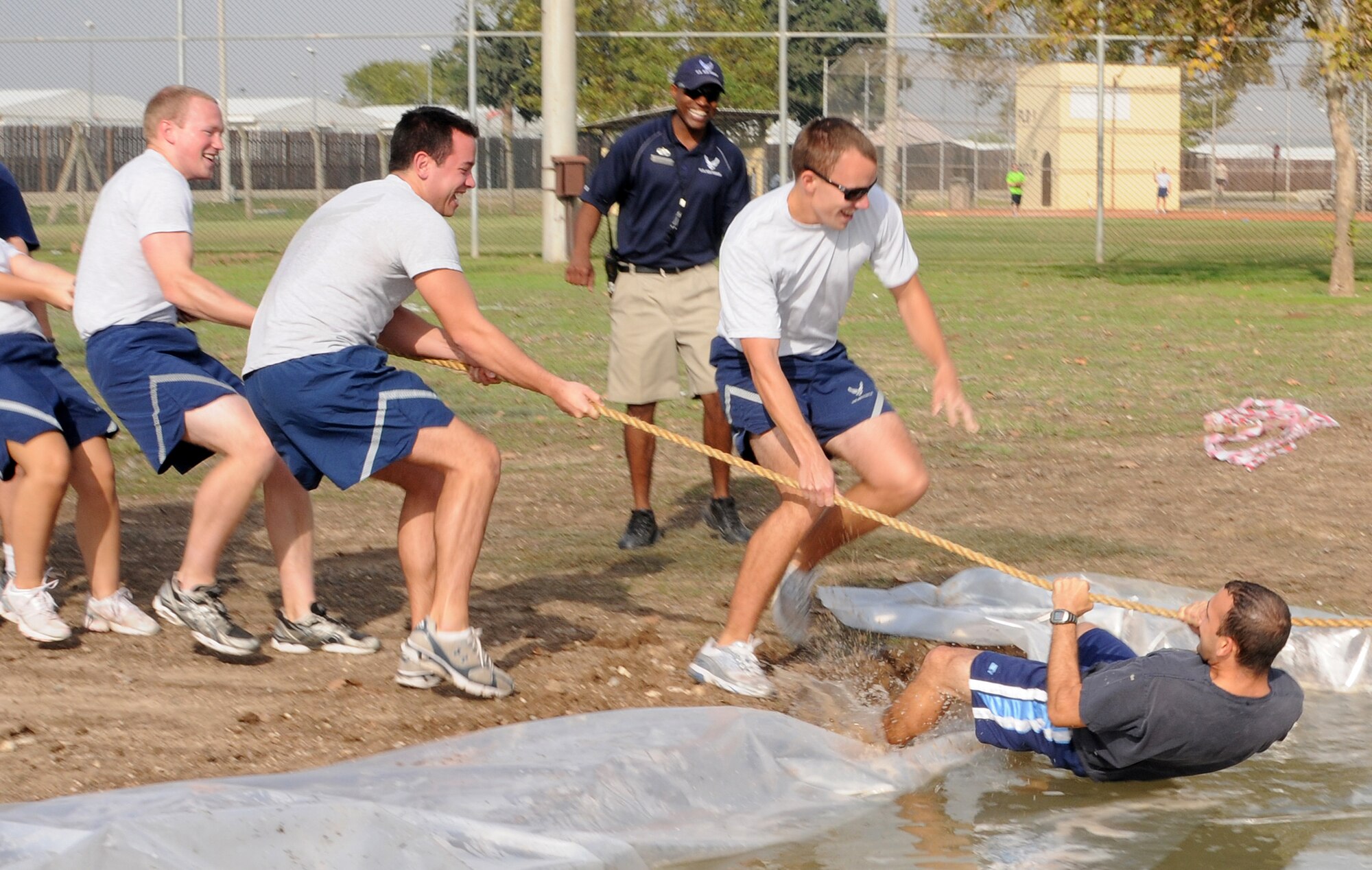 Staff Sgt. Rob Thomas, 39th Operations Squadron, gets pulled in the water by Airmen of the 39th Logistics Readiness Squadron, during tug of war on Wing Sports Day, Monday, Nov. 9, 2009 at Incirlik’s Arkadas Park.  The 39th Security Forces Squadron won the tug of war portion of the overall event.  They also gained the most points throughout the day, earning the squadron the Sports Day trophy which will be passed to different winners each year. (U.S. Air Force photo/Senior Airman Ashley Wood)  