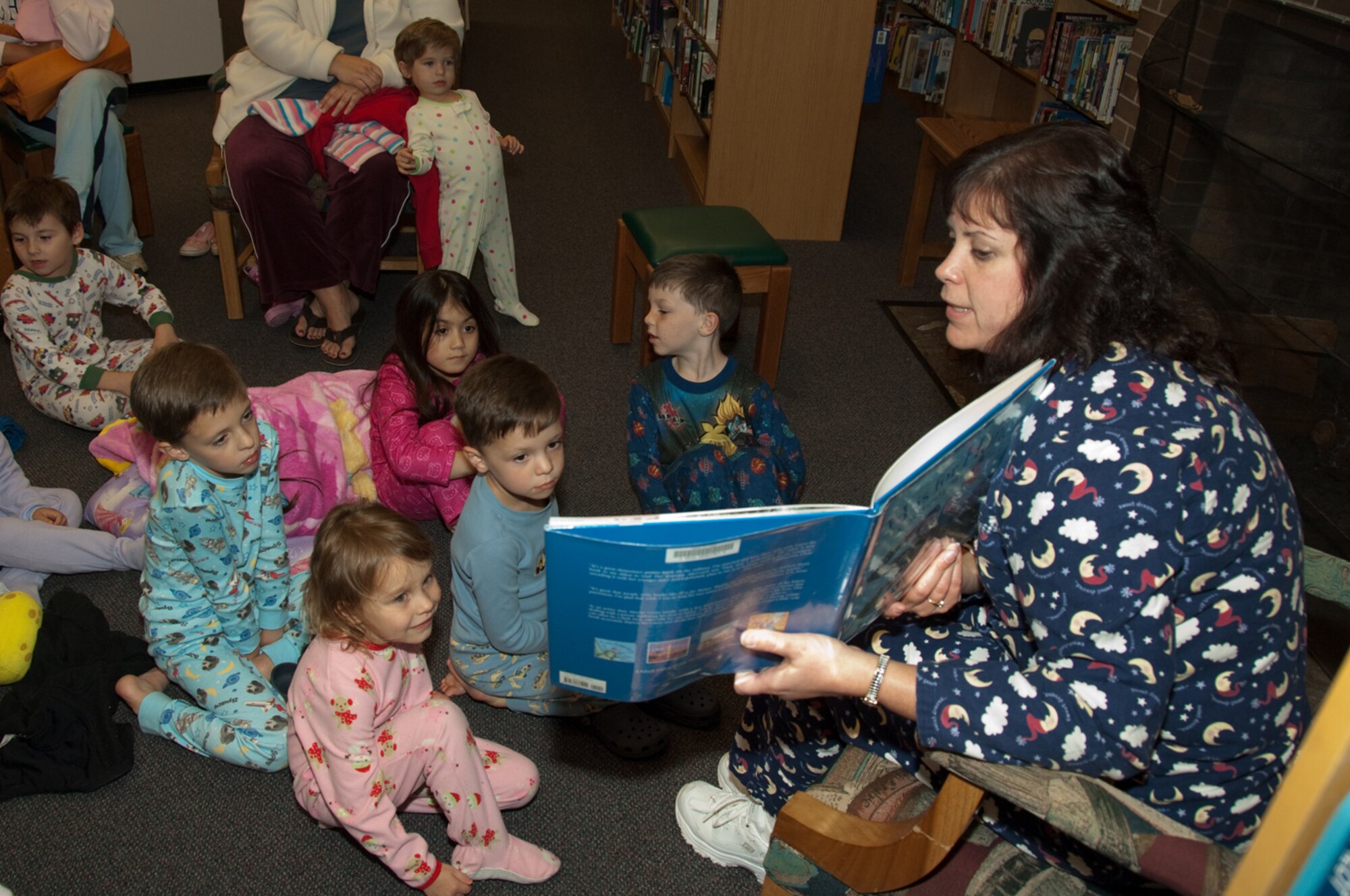 HANSCOM AIR FORCE BASE, Mass. – Eve Peabody, 66th Force Support Squadron, reads a story to children at the Base Library on Nov. 4, during PJ Story Time. The story time event was one of many activities that took place across the base in celebration of Air Force Family Week. For more information on events taking place at the Library go to www.hanscomservices.com. (U.S. Air Force photo by Rick Berry)