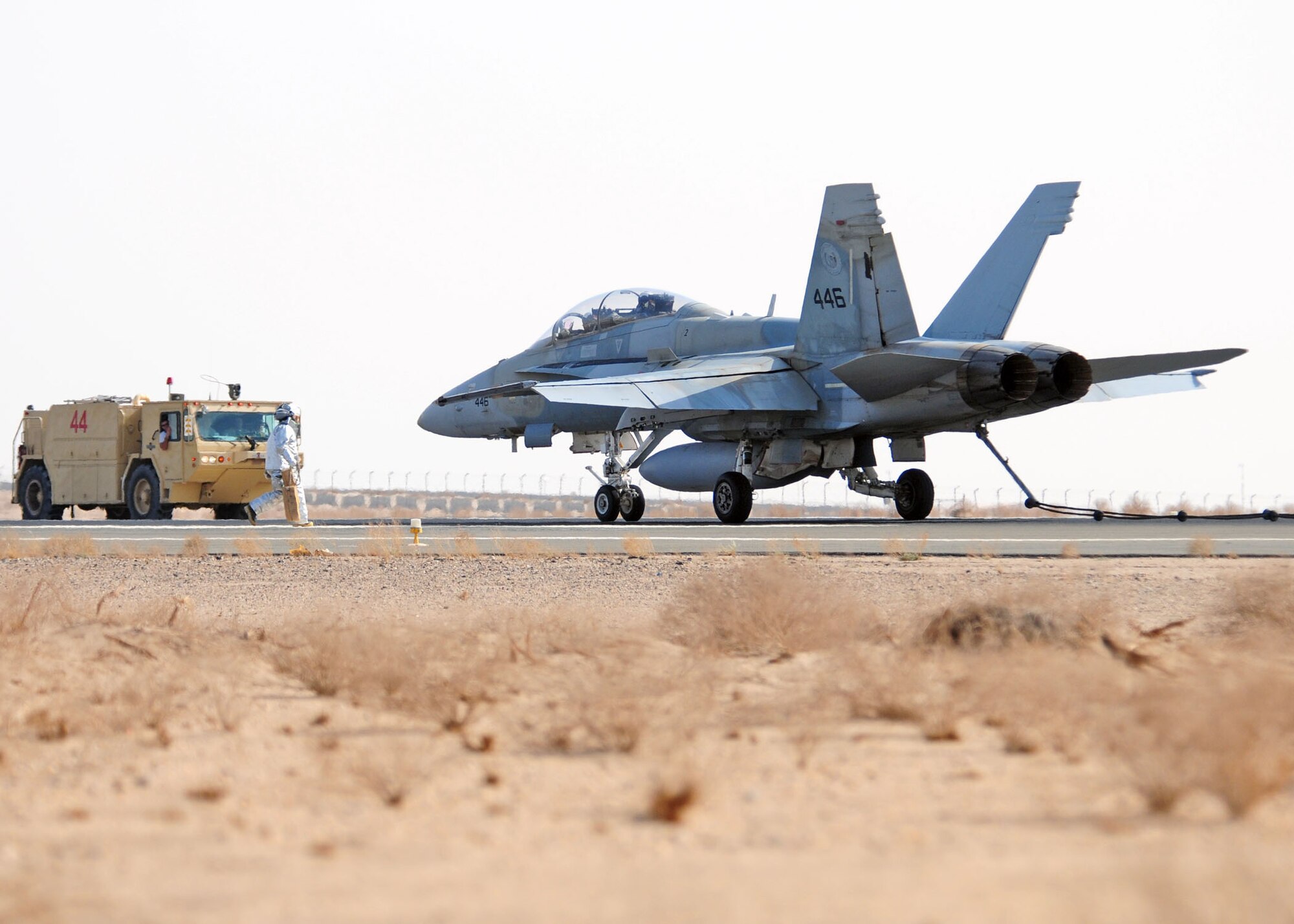 SOUTHWEST ASIA -- A 386th Expeditionary Civil Engineer Squadron firefighter prepares to chalk the tires of a host nation F/A-18 Hornet after a successful mobile aircraft arresting system test at an air base in Southwest Asia Nov. 9, 2009.  (U.S. Air Force photo/Tech. Sgt. Tony Tolley)