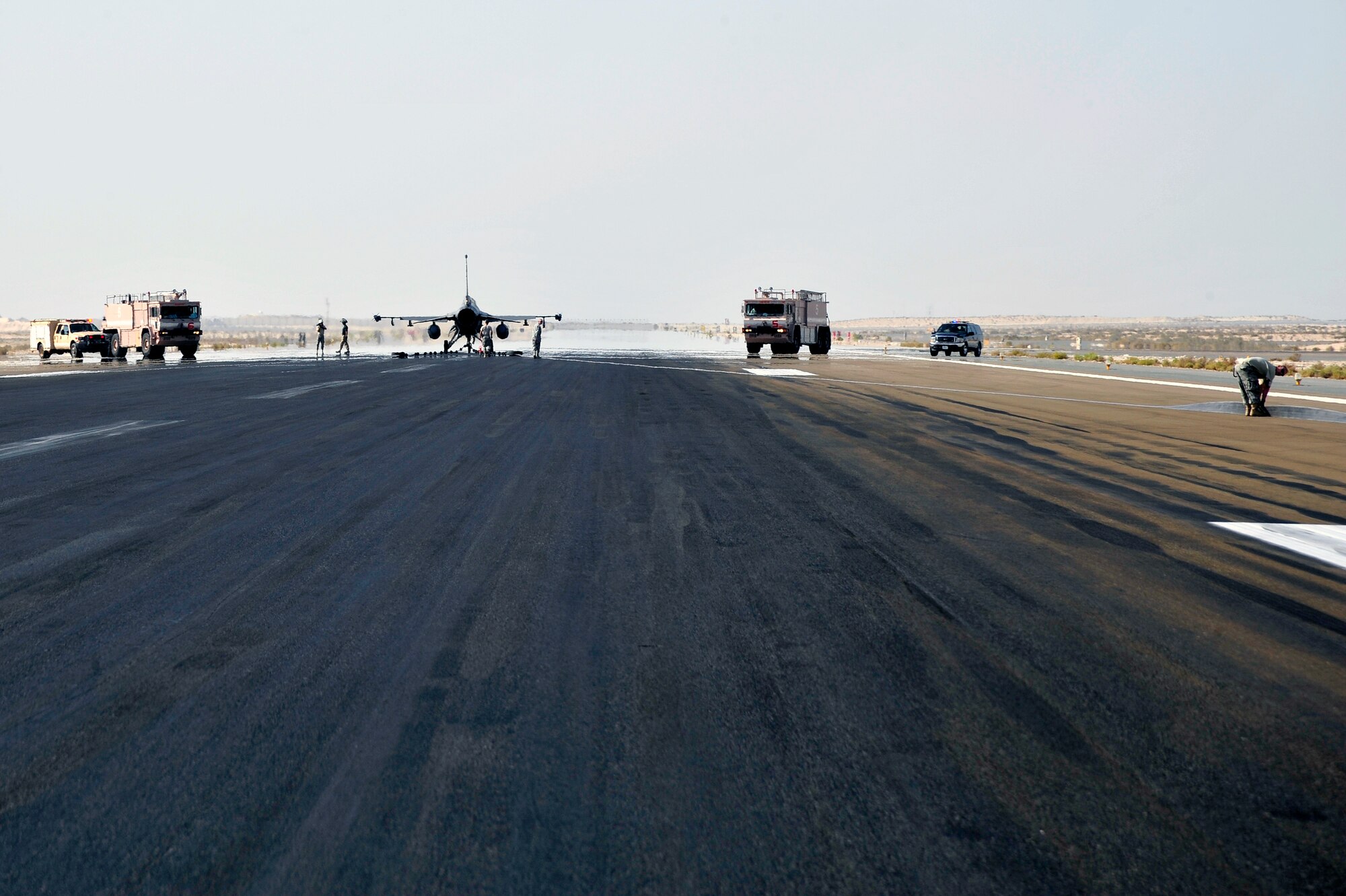 SOUTHWEST ASIA -Airmen of the 380th Expeditionary Civil Engineer Squadron, recover a mobile aircraft arresting system (MAAS) cable following the annual certification Nov. 8, 2009. The 380th ECES personnel from barrier maintenance and fire department straightened the cable before it was reeled back in. (U.S. Air Force photo/Tech. Sgt. Charles Larkin Sr)