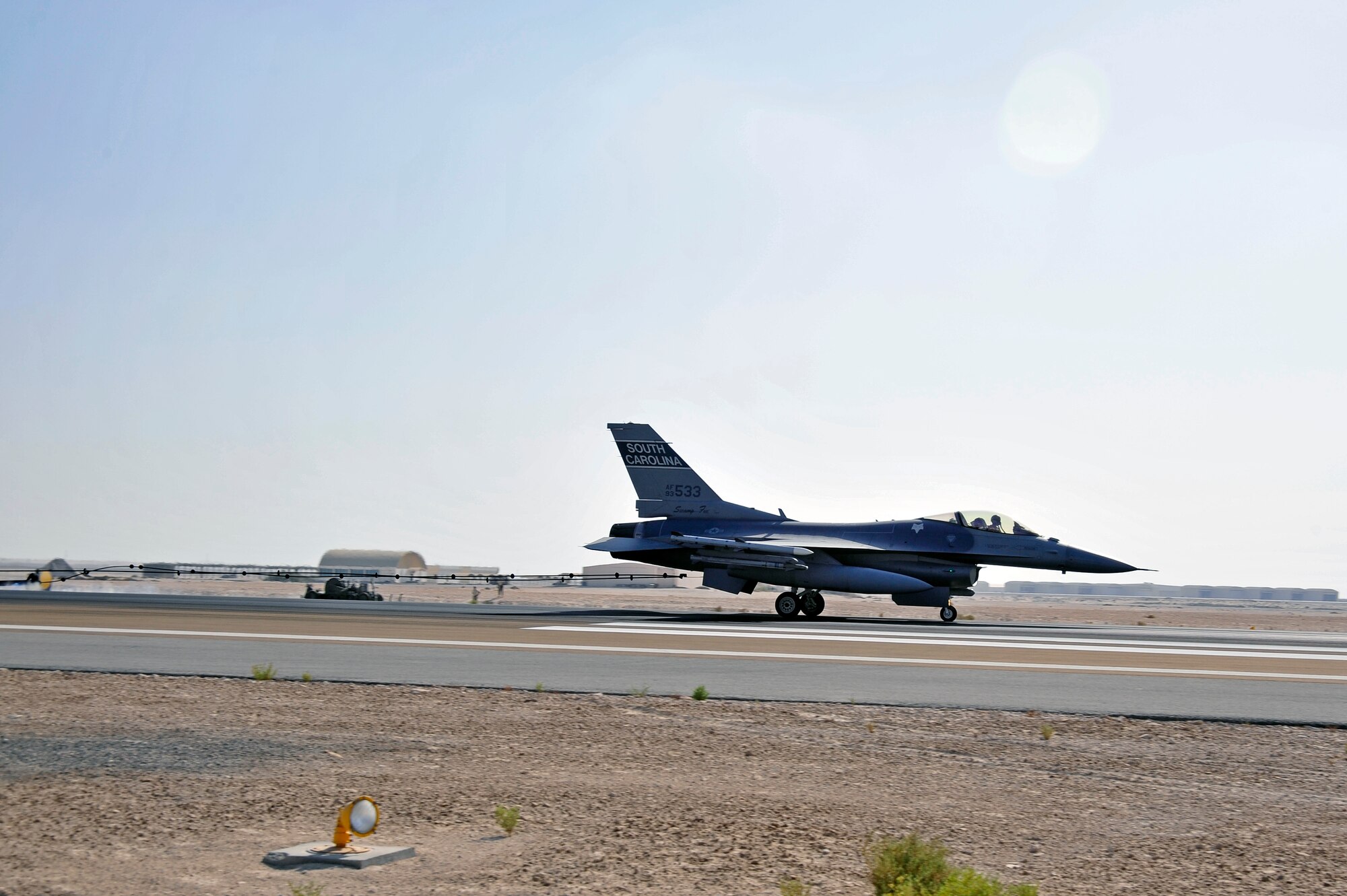SOUTHWEST ASIA -An F-16 Fighting Falcon decelerates after catching a mobile aircraft arresting system (MAAS) cable while taxiing the runway Nov. 8, 2009. The 380th Air Expeditionary Wing's mobile aircraft arresting system was tested to complete an annual certification used to ensure the system works properly. (U.S. Air Force photo/Tech. Sgt. Charles Larkin Sr)
