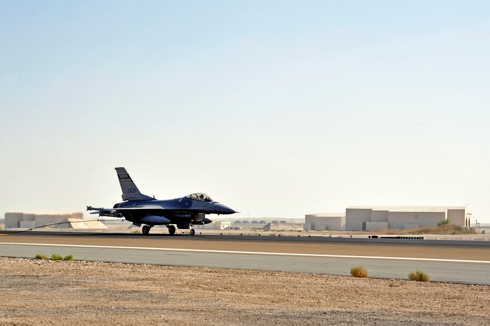 SOUTHWEST ASIA -An F-16 Fighting Falcon hooks a mobile aircraft arresting system (MAAS) cable while taxiing the runway Nov. 8, 2009. The mobile aircraft arresting system was tested to complete an annual certification used to ensure the system works properly. (U.S. Air Force photo/Tech. Sgt. Charles Larkin Sr)