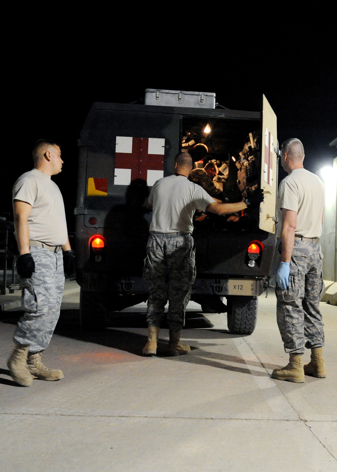 JOINT BASE BALAD, Iraq -- Volunteers prepare to help patients off of an ambulance to direct them to the emergency room at the Air Force Theater Hospital Nov. 2, 2009. Volunteers also help gather patients' belongings and supplement personnel resources in case of a mass-casualty event. (U.S. Air Force photo/Senior Airman Christopher Hubenthal)