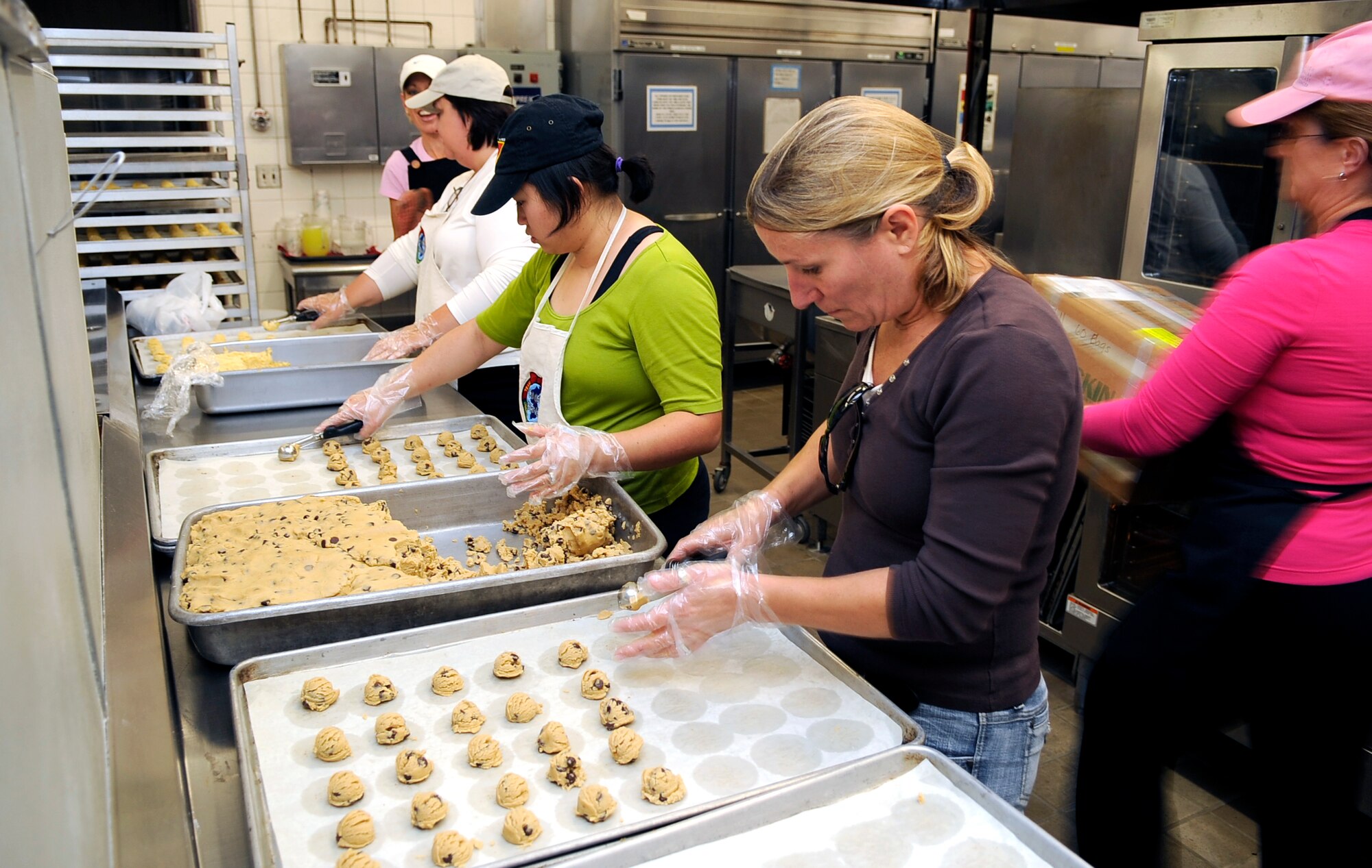 Volunteers from accross the base prepare sheets of cookie dough during the annual "Cookie Crunch" at Osan Air Base, Republic of Korea. The Cookie Crunch program is hosted by the Osan Officer's Spouses Club and base leadership to bring a taste of home to all Airmen, Soldiers, Sailors, Marines and Korean Airmen on the peninsula. (U.S. Air Force photo/Staff Sgt. Brian Ferguson)





