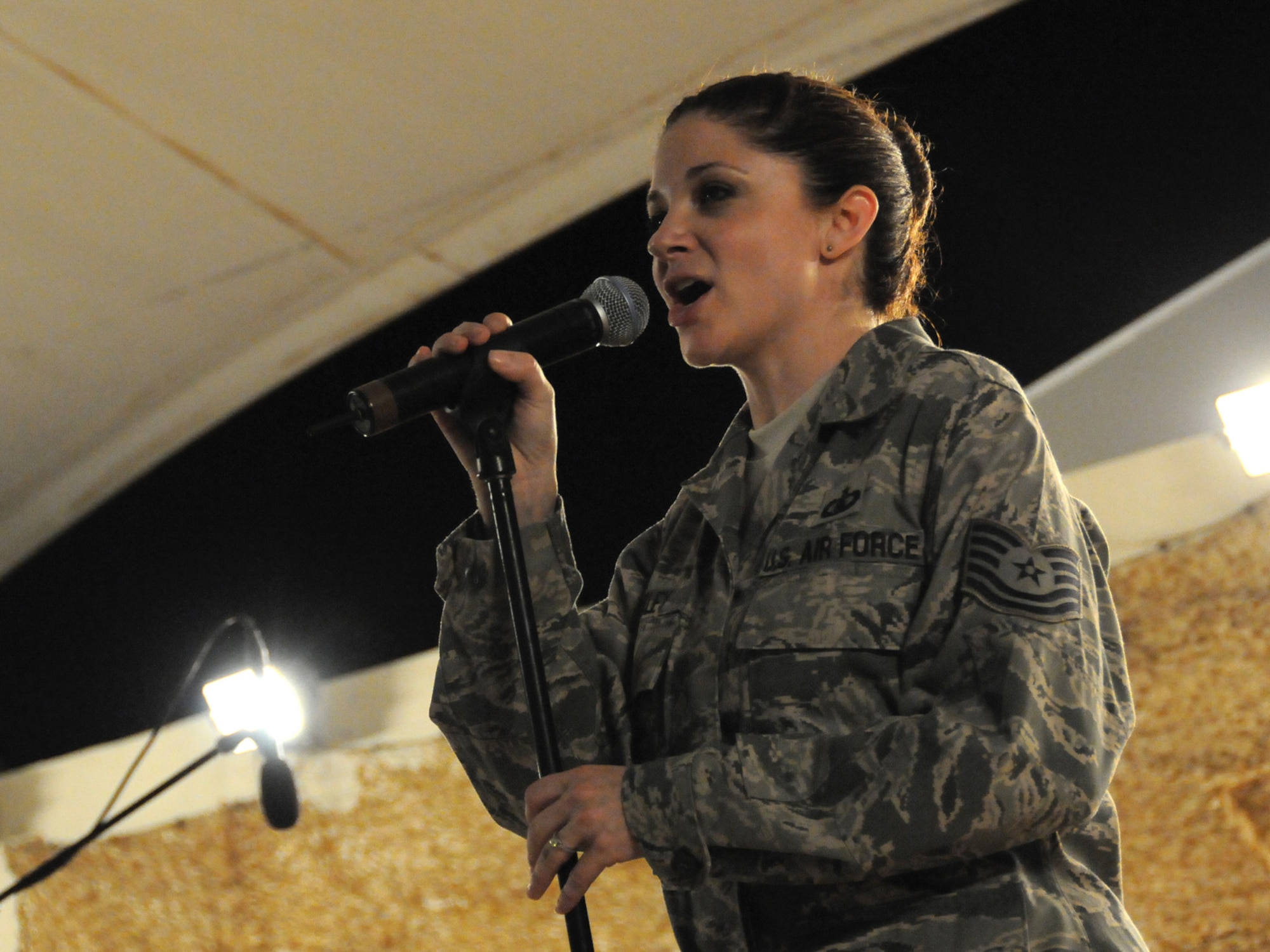 Tech. Sgt. Christin Foley, Air Forces Central Command band vocalist, performs for an audience of deployed service members at an undisclosed location in Southwest Asia, Nov. 7, 2009. The band is deployed from Lackland Air Force Base, Texas in support of operations Iraqi Freedom and Enduring Freedom. (U.S. Air Force Photo/Tech. Sgt. Jason W. Edwards)