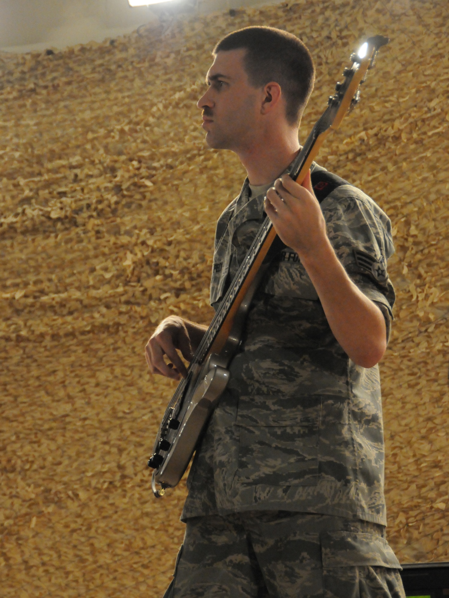 Senior Airman Andrew Peck, Air Forces Central Command band bassist, performs with the band Sirocco for an audience of deployed servicemembers at an undisclosed location in Southwest Asia, Nov. 7, 2009. Sirocco is deployed from Lackland Air Force Base, Texas in support of operations Iraqi Freedom and Enduring Freedom. (U.S. Air Force Photo/Tech. Sgt. Jason W. Edwards)