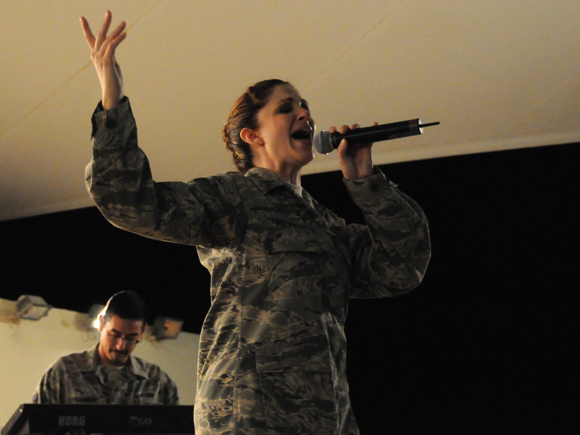 Tech. Sgt. Christin Foley, Air Forces Central Command band vocalist, performs with the band Sirocco for an audience of deployed servicemembers at an undisclosed location in Southwest Asia, Nov. 7, 2009. Sirocco is deployed from Lackland Air Force Base, Texas in support of operations Iraqi Freedom and Enduring Freedom. (U.S. Air Force Photo/Tech. Sgt. Jason W. Edwards)
