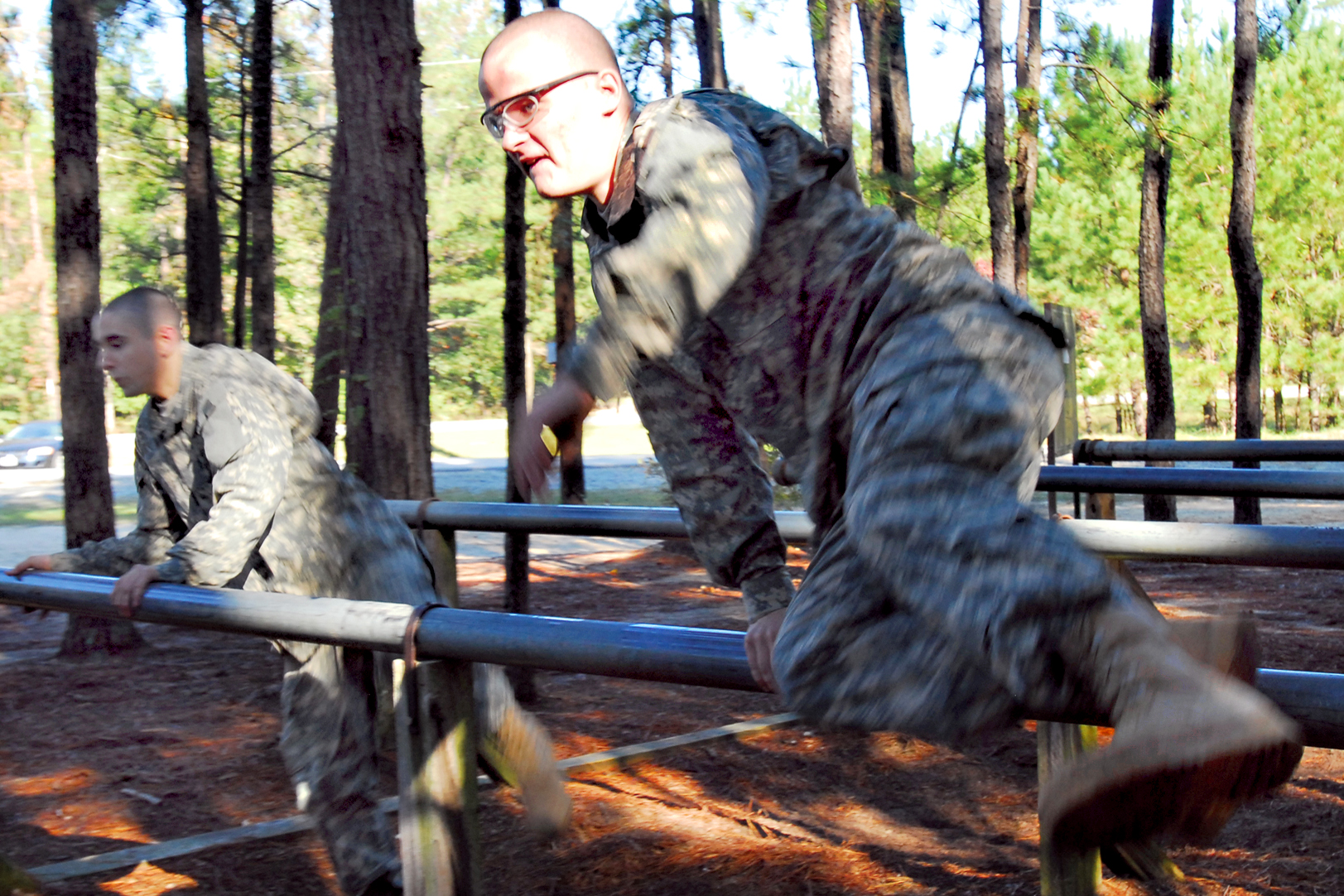 U.S. Army infantry recruits leap over hurdles at the Sand Hill 