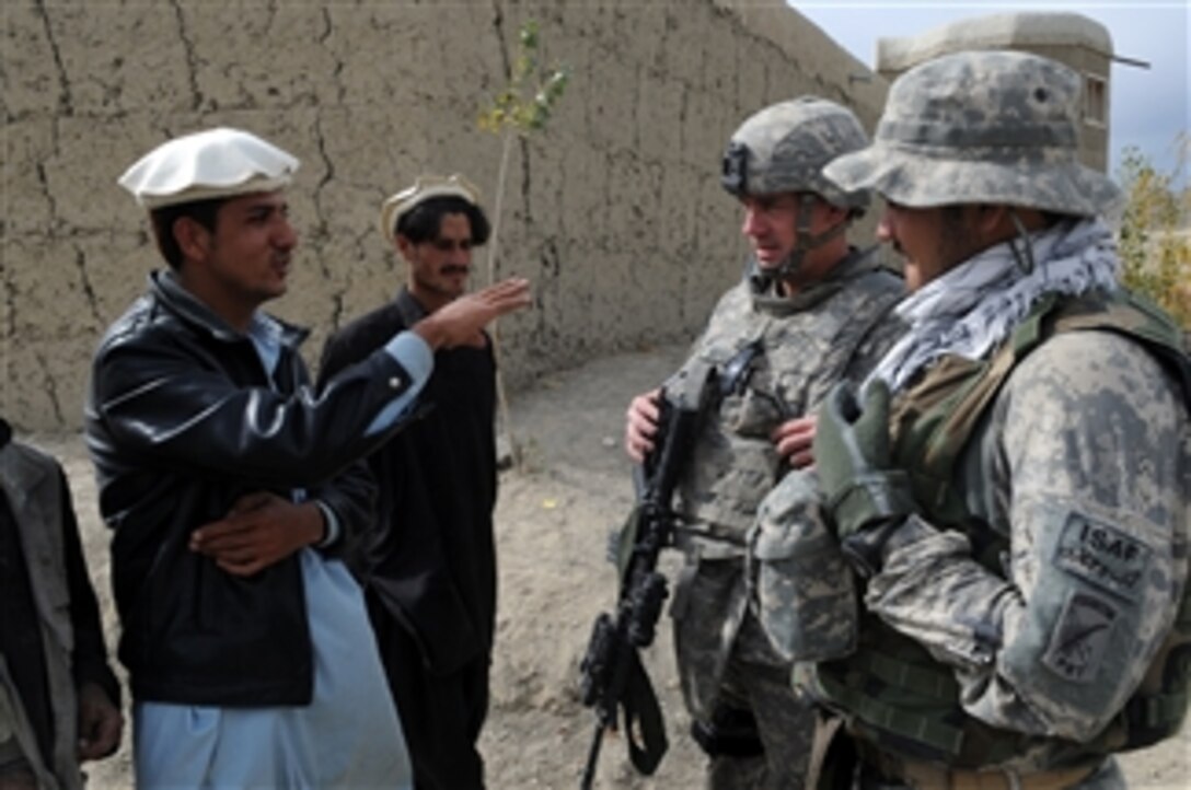 U.S. Army Sgt. 1st Class Dwight Bevill, a civil affairs member with Provincial Reconstruction Team Paktika, talks to an Afghan man about local issues in Zama, Afghanistan, on Nov. 2, 2009.  The Provincial Reconstruction Team civil affairs members are talking with village leaders to assess the needs of the area in order to plan future development projects.  