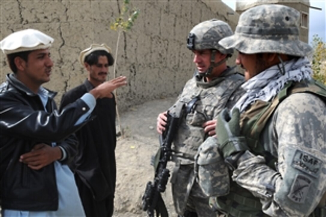 U.S. Army Sgt. 1st Class Dwight Bevill talks to an Afghan man about local issues in Zama, Afghanistan, Nov. 2, 2009. Bevill is assigned to Provincial Reconstruction Team Paktika, and meets with villages leaders to plan future development projects.