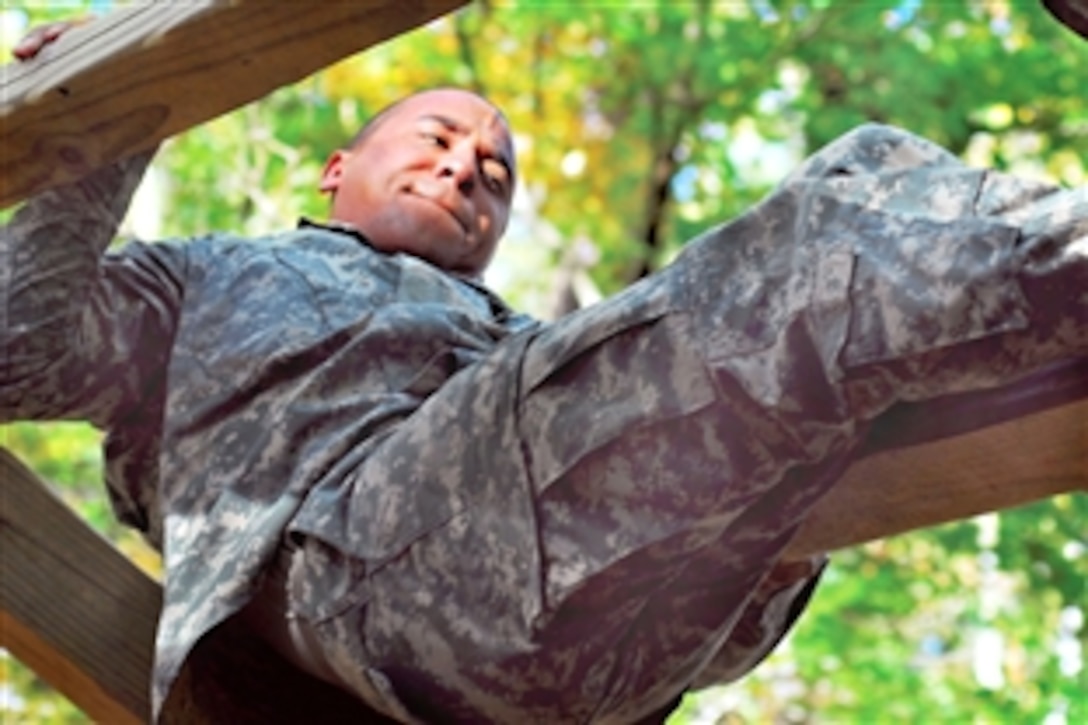 A U.S. Army Infantry recruit tries to hang on as he attempts to swing under a plank during the confidence course on their fifth day training on Fort Benning, Ga., Nov. 3, 2009. The soldier is an infantry recruit assigned to Company B, 1st Battalion, 19th Infantry Regiment, 198th Infantry Brigade.
