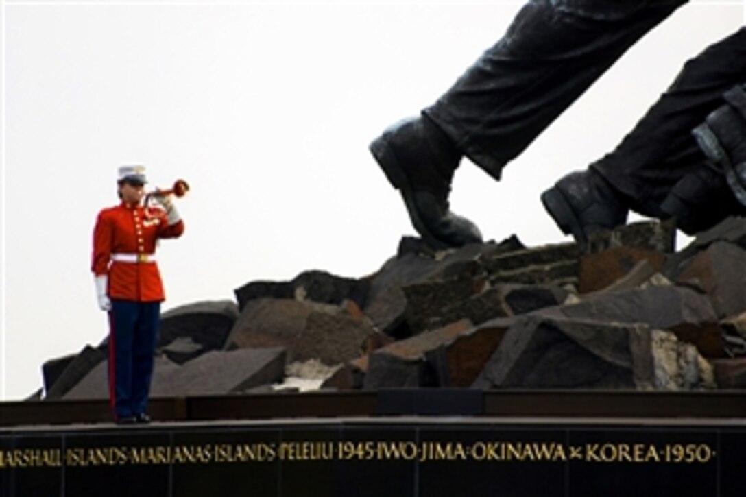 A U.S. Marine sounds Taps during a wreath-laying ceremony at the Marine Corps Memorial to honor the 234th anniversary of the U.S. Marine Corps in Arlington, Va., Nov. 10, 2009.