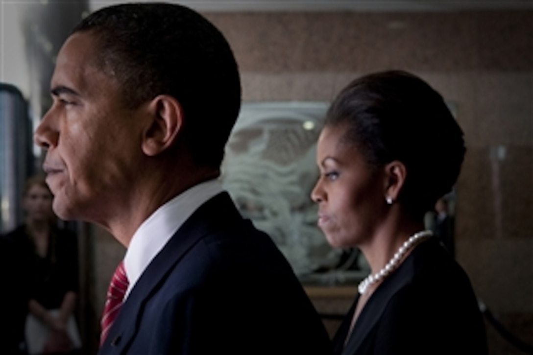 President Barack Obama and First Lady Michelle Obama prepare to take part  in a Nov. 10, 2009, ceremony at Fort Hood, Texas, to honor the victims of the Nov. 5 shooting rampage that left 13 dead and 38 wounded.
