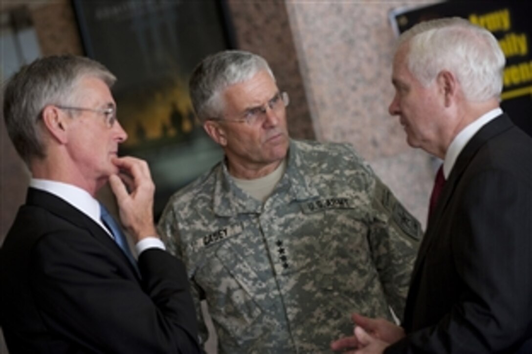 Defense Secretary Robert M. Gates, right, Army Secretary John M. McHugh, left, and Army Chief of Staff Gen. George W. Casey Jr., center, at Fort Hood, Texas, participate a Nov. 10, 2009, ceremony to honor the victims of the Nov. 5 shooting rampage that left 13 dead and 38 wounded.