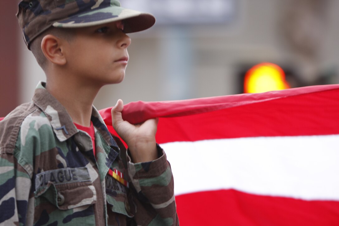 PALM SPRINGS, Calif. - Nine-year-old Victor Olague, a member of the Young Marines, clutches the American Flag Wednesday during the 13th annual Veteran's Day Parade in downtown Palm Springs, Calif. Marines from the Combat Center were also present in the parade and festivities before and after.