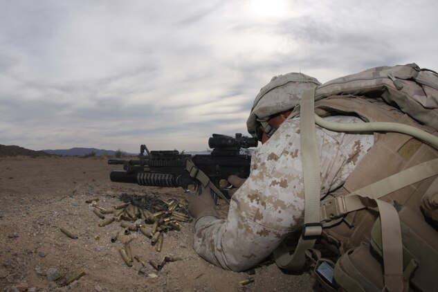 Lance Cpl. Ashton Jones, a rifleman with Company G, 2nd Battalion, 7th Marine Regiment, provides security as Marines in his squad push through obstacles and an ambush on the way to a raid at the Combat Center's Range 205 Nov. 11. This training was the last the company will undergo before their January deployment with the 31st Marine Expeditionary Unit in January.